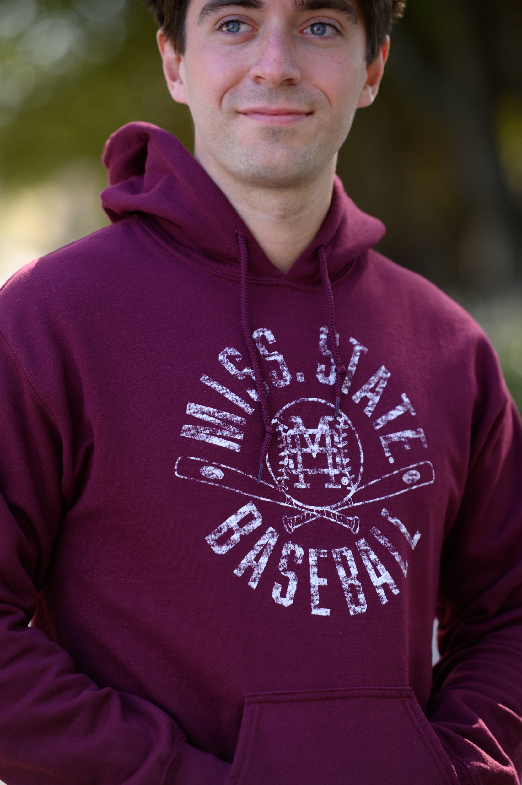 Mississippi State Distressed Dark Red Hoodie with a White Baseball featuring the MS overlapping logo over crossed baseball bats, surrounded by White text “Miss. State Baseball”
