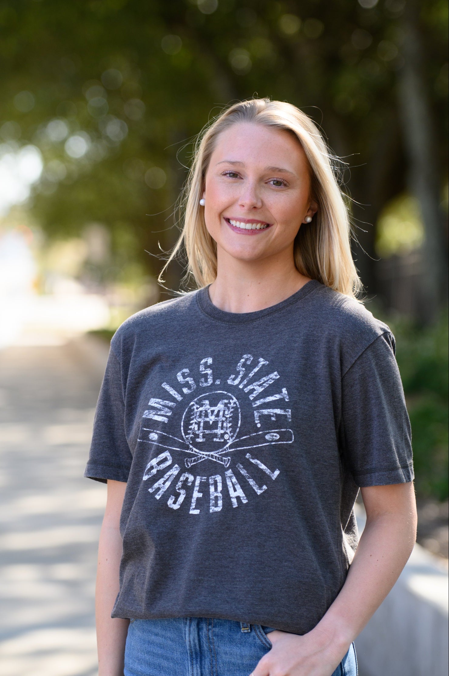 Mississippi State Distressed Dark Grey T-Shirt with a White Baseball featuring the MS overlapping logo over crossed baseball bats, surrounded by White text “Miss. State Baseball”