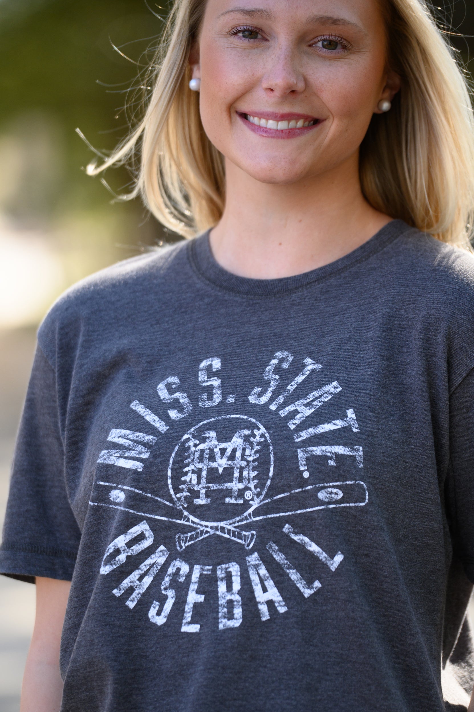 Mississippi State Distressed Dark Grey T-Shirt with a White Baseball featuring the MS overlapping logo over crossed baseball bats, surrounded by White text “Miss. State Baseball”