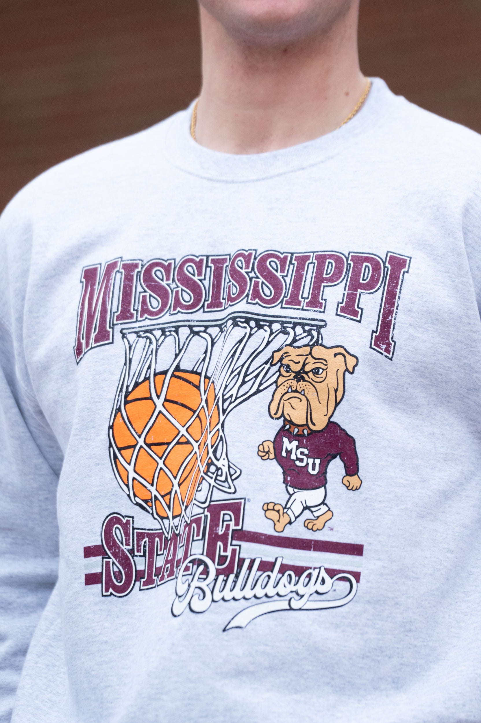 Mississippi State Light Grey Heather Sweatshirt with a basketball landing in a hoop between text “Mississippi” and “State” and next to Bully