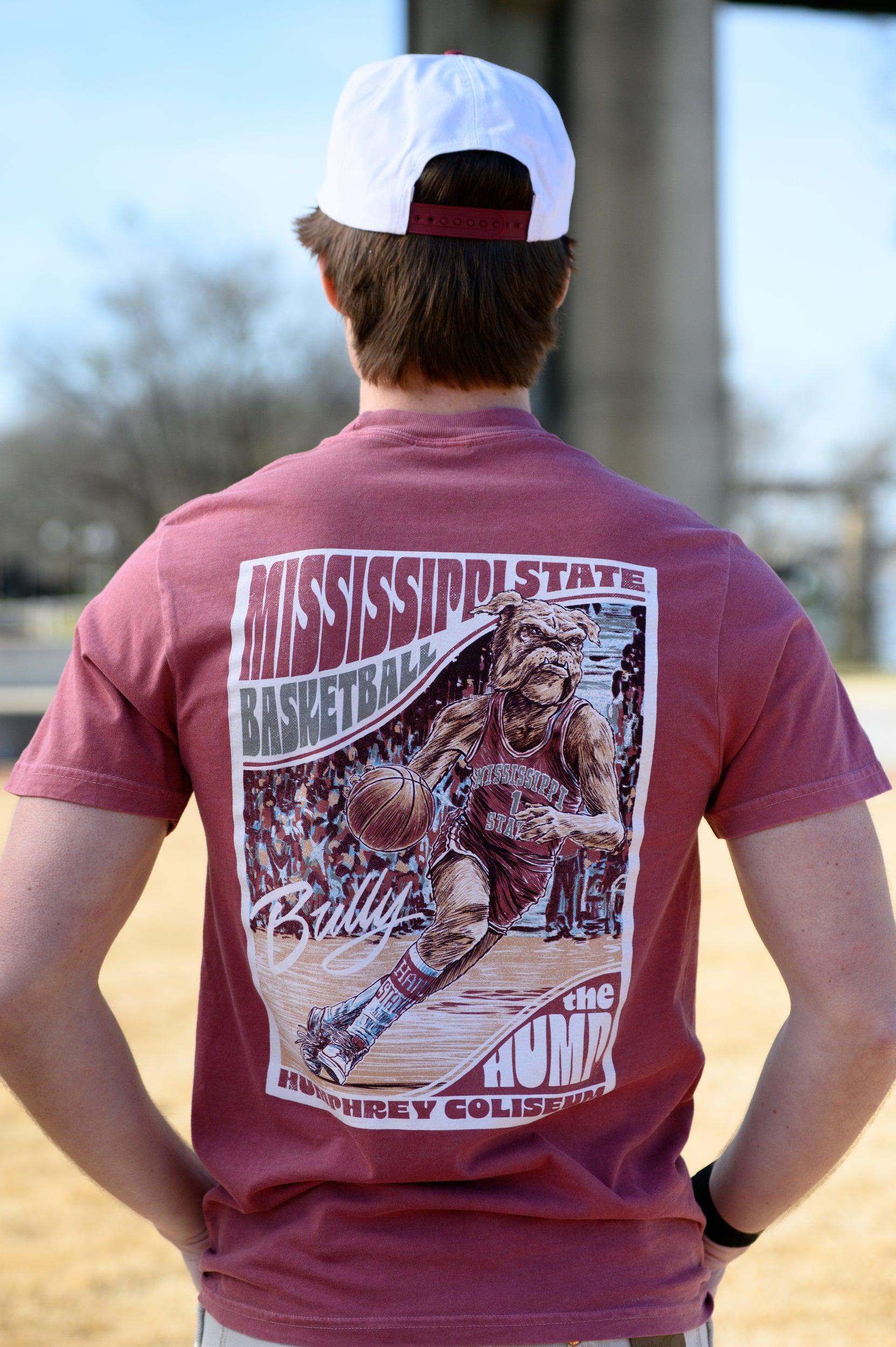 Mississippi State Crimson T-Shirt with a basketball card style design featuring Bully dribbling a basketball down the court in between text “Mississippi State Basketball” and “The Hump Humphrey Coliseum,” and with an autograph from Bully