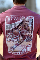 Mississippi State Crimson T-Shirt with a basketball card style design featuring Bully dribbling a basketball down the court in between text “Mississippi State Basketball” and “The Hump Humphrey Coliseum,” and with an autograph from Bully