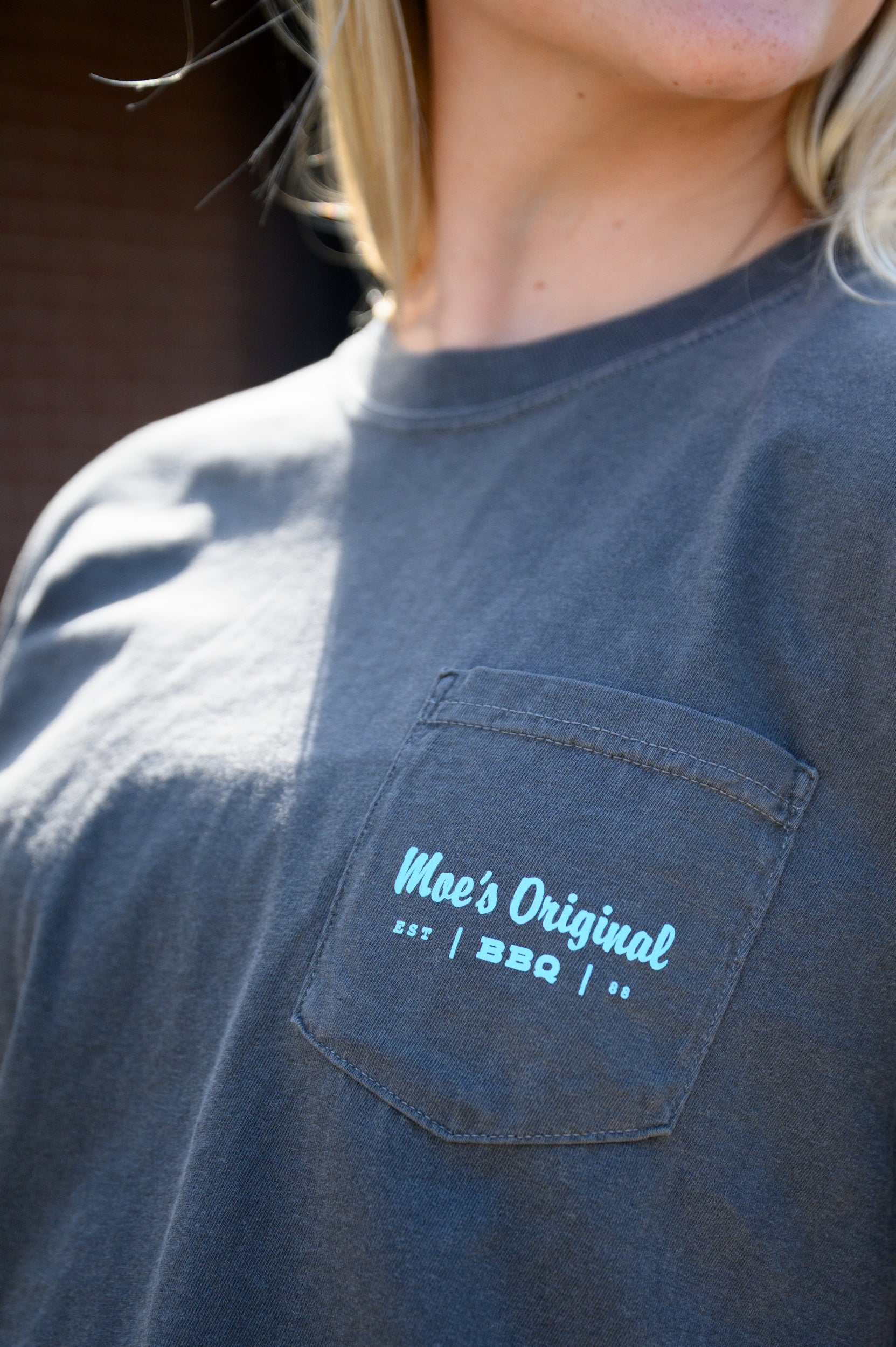Blue “Moe’s BBQ” logo front pocket design