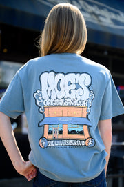 Moe's Dusty Blue T-Shirt with White text "Moe's Original Barbeque" above an illustration of the Moe’s BBQ Building