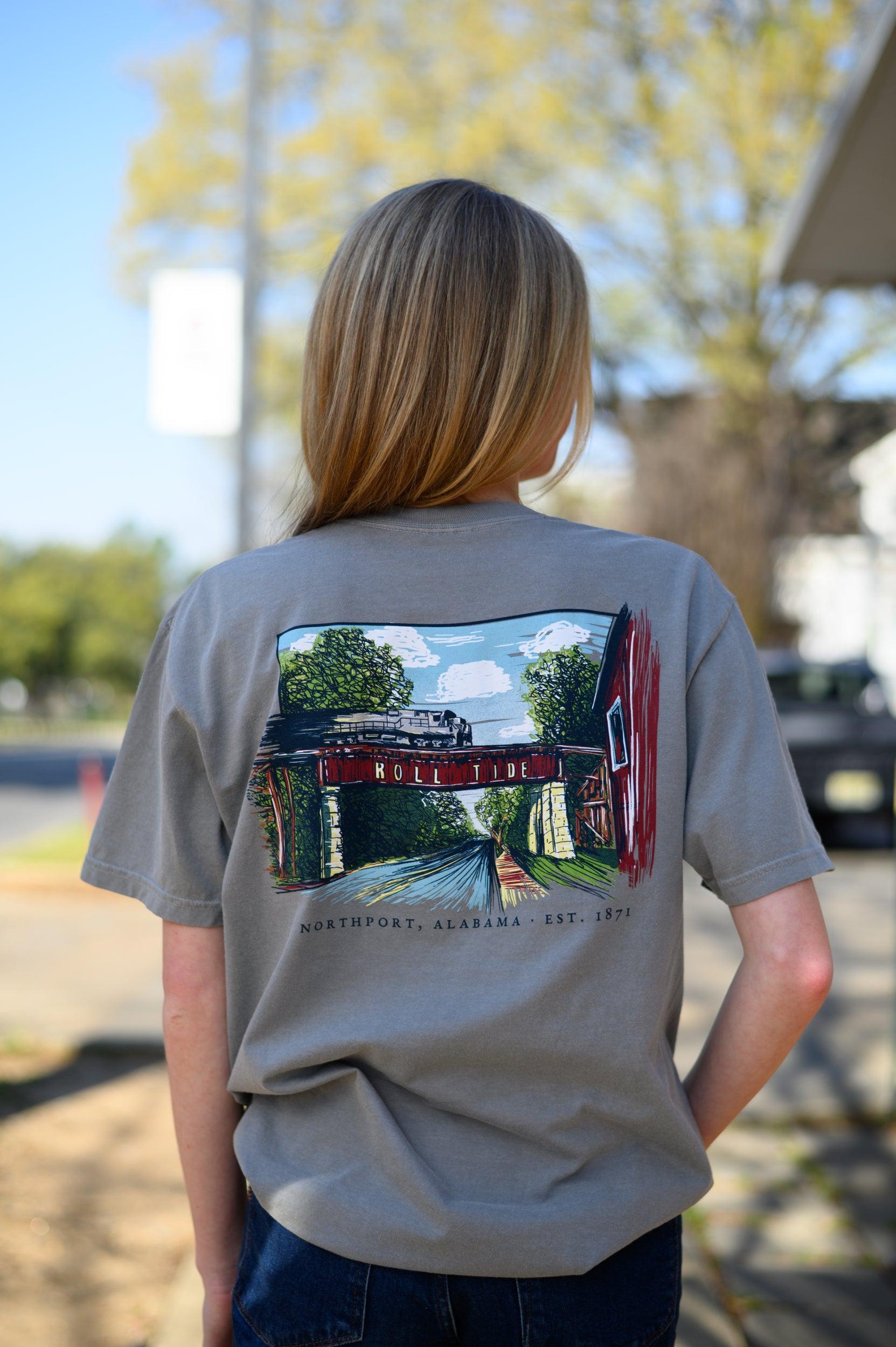 Local Merch Grey T-Shirt with a hand-drawn illustration of the Downtown Northport Train tracks above Black text "Northport, Alabama EST. 1871"