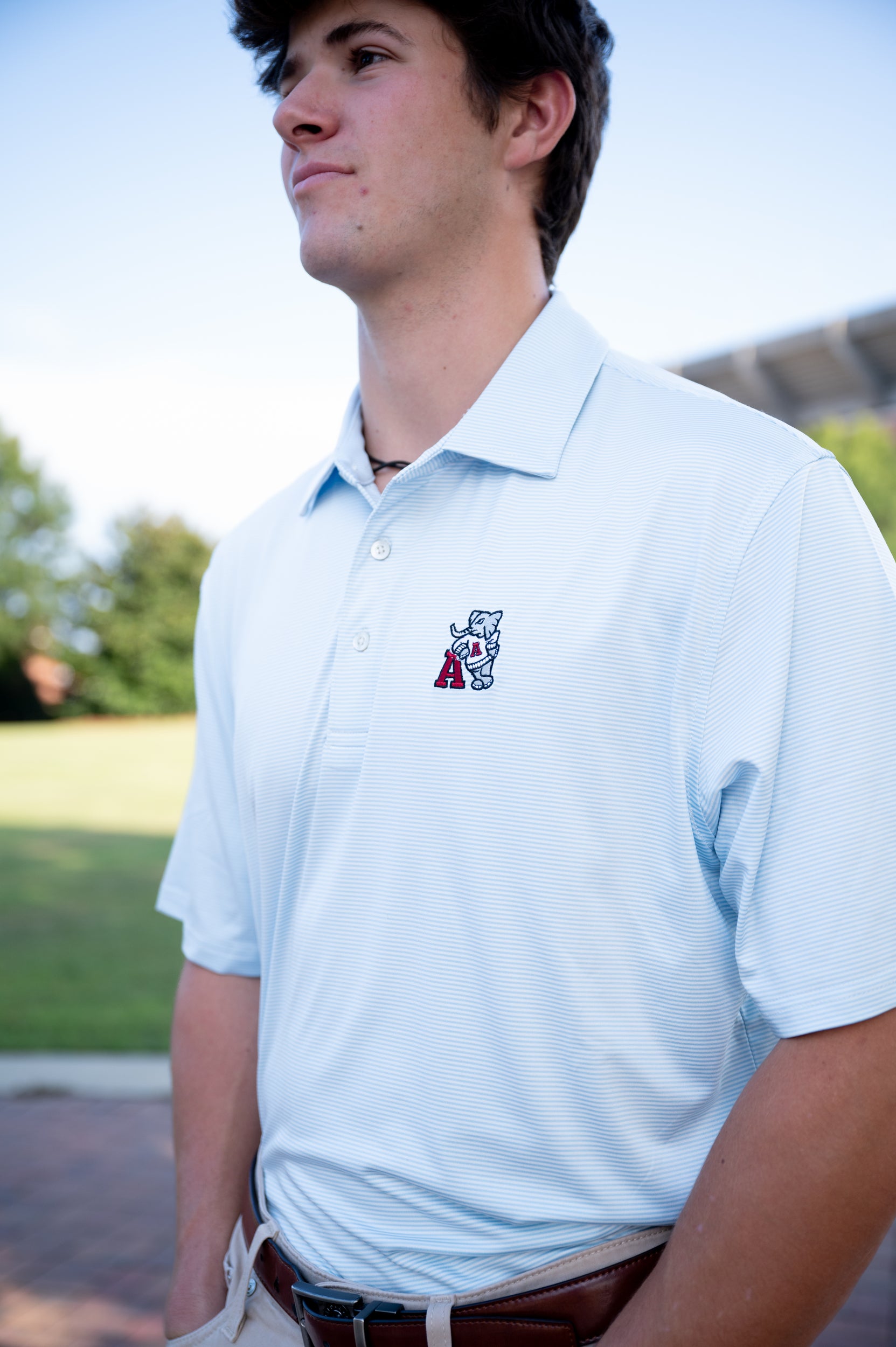 University of Alabama Light Blue Men’s Stripe Polo with embroidery of Big Al leaning on a Red Block A