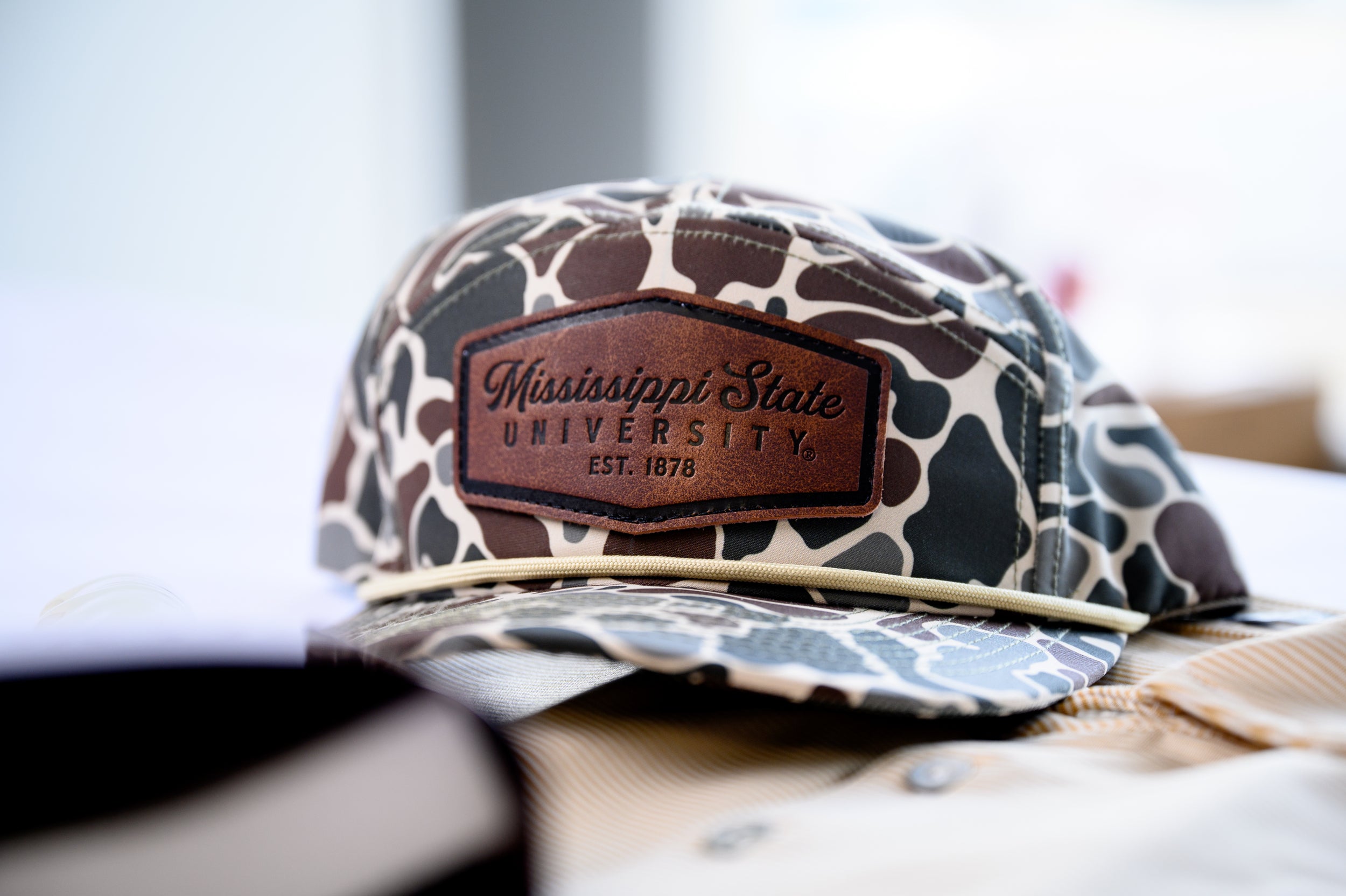 Ole Miss Camo Hat with a Leather patch with text “Mississippi University”