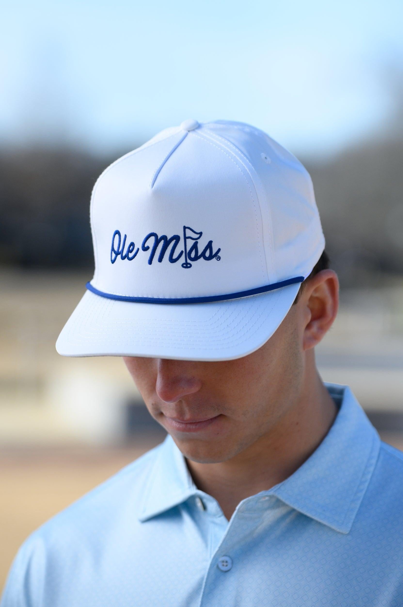 Ole Miss White Hat with Blue embroidery “Ole Miss” with a golf flag representing the “I” in “Miss”