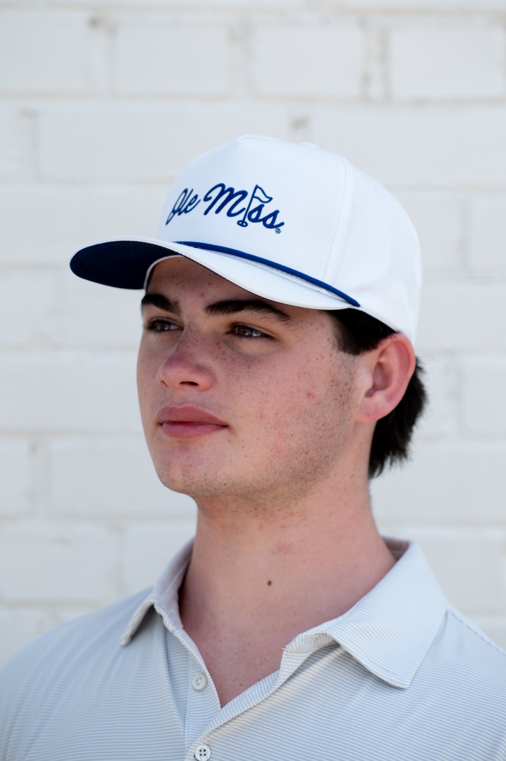 Ole Miss White Hat with Blue embroidery “Ole Miss” with a golf flag representing the “I” in “Miss”