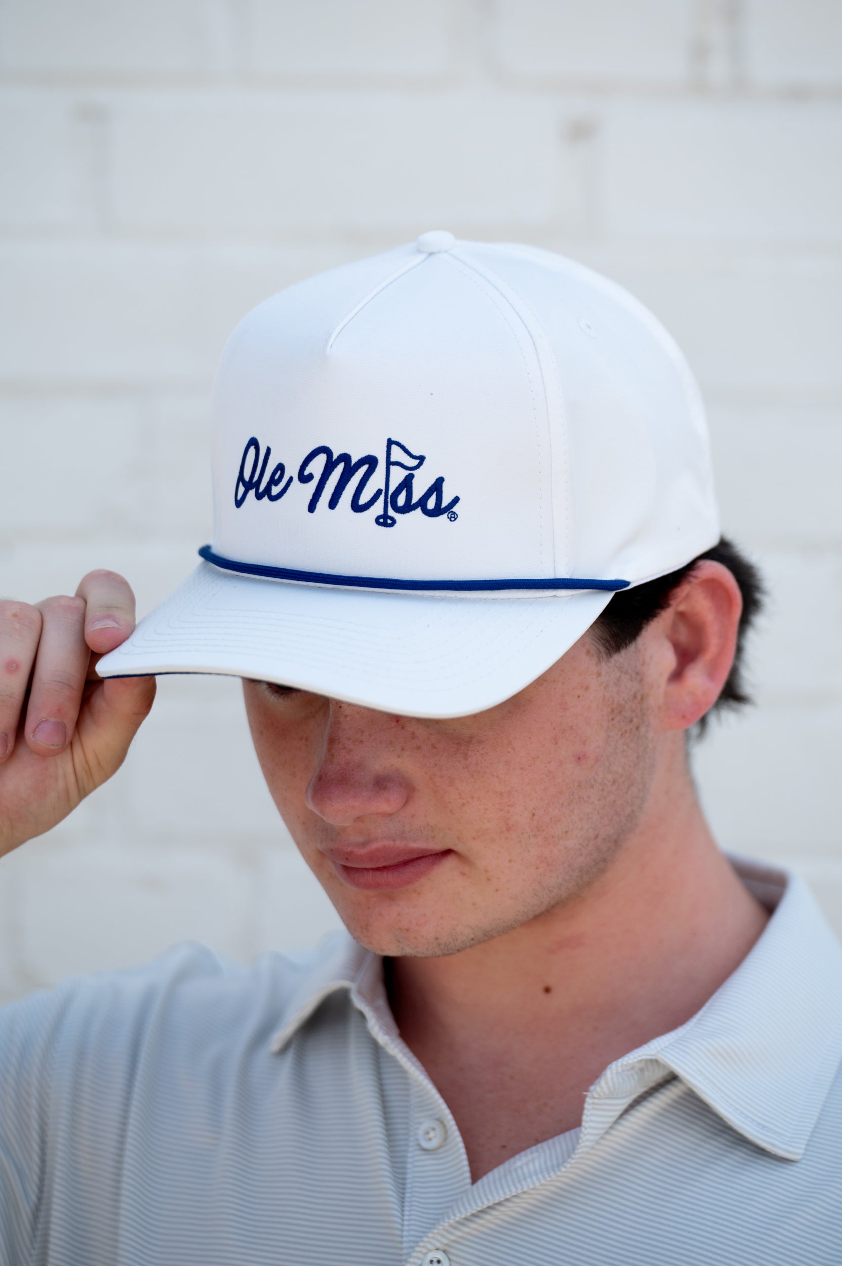 Ole Miss White Hat with Blue embroidery “Ole Miss” with a golf flag representing the “I” in “Miss”