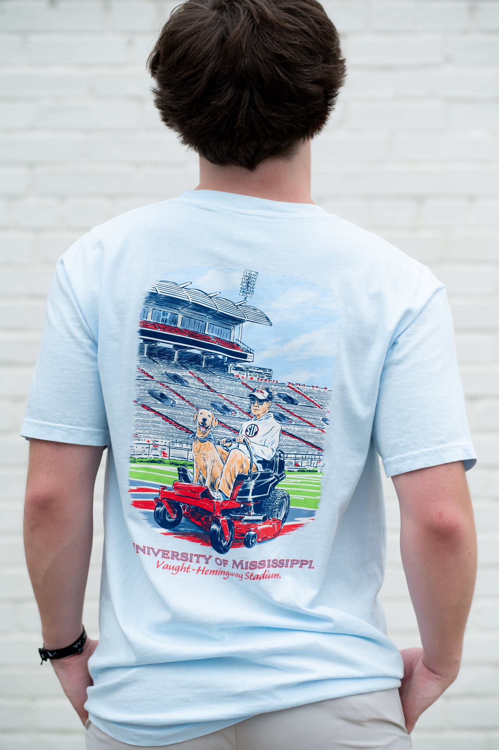 Ole Miss Light Blue Ole Miss Grounds Crew T-Shirt with an image of Lane Kiffin and Juice riding a lawnmower