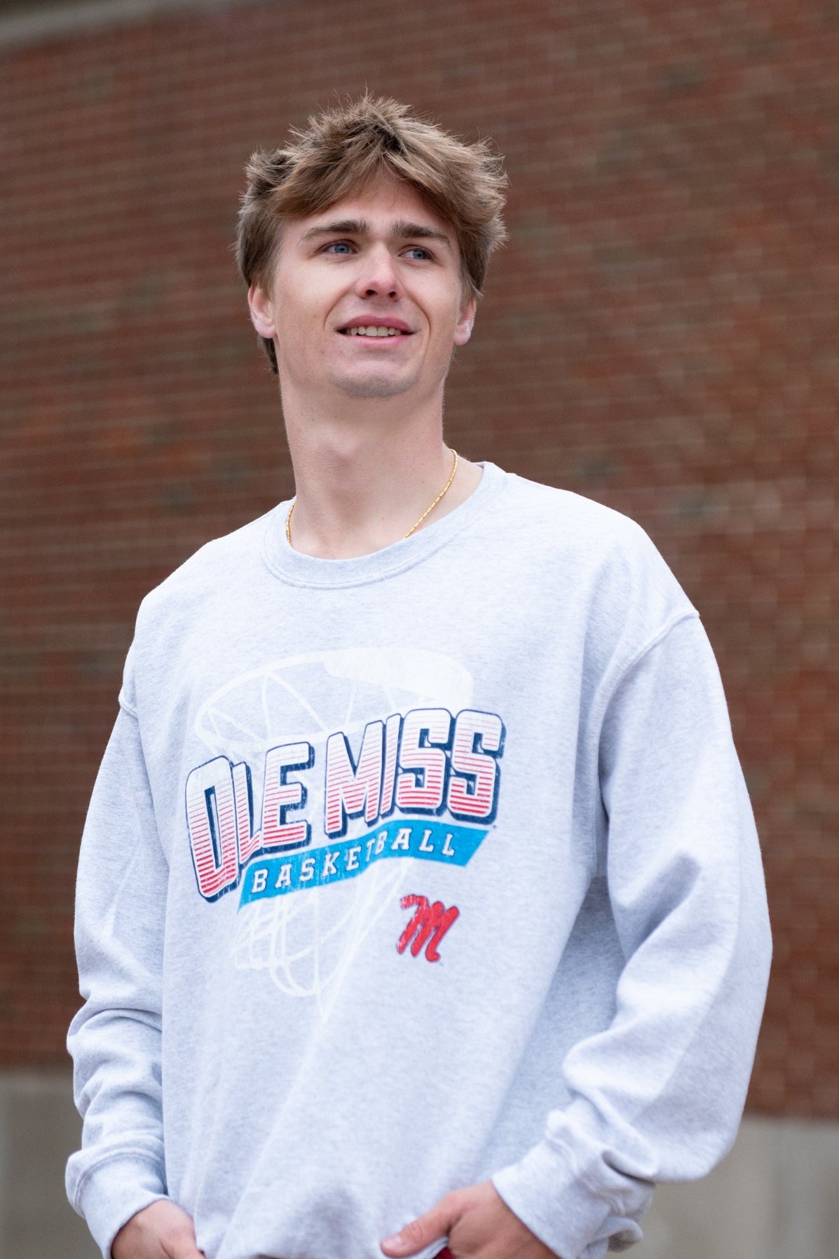 Ole Miss Light Grey Heather Sweatshirt with a basketball hoop outline behind text “Ole Miss Basketball”