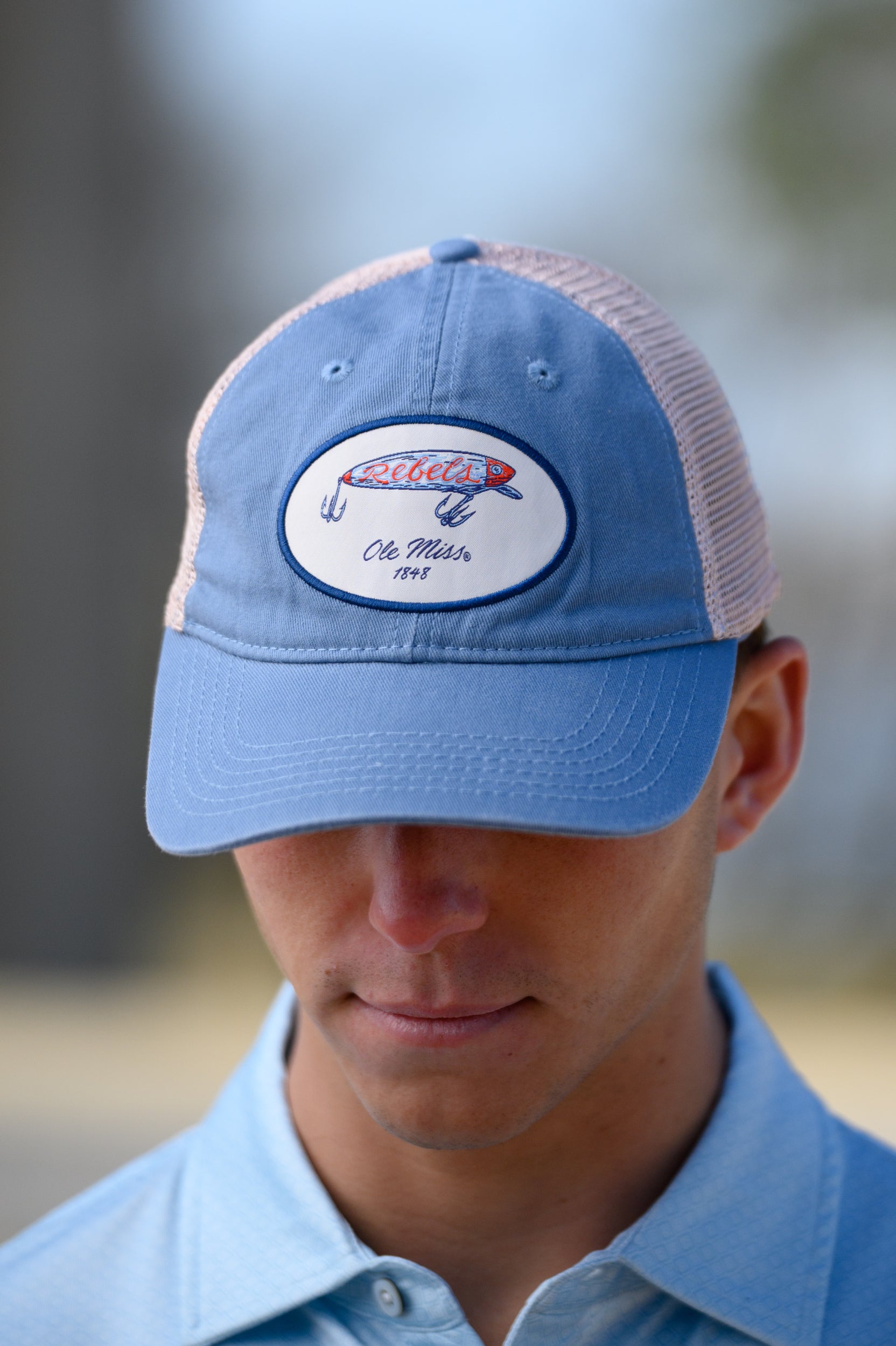 Ole Miss Dusty Blue Hat with a fishing lure with Red script “Rebels”