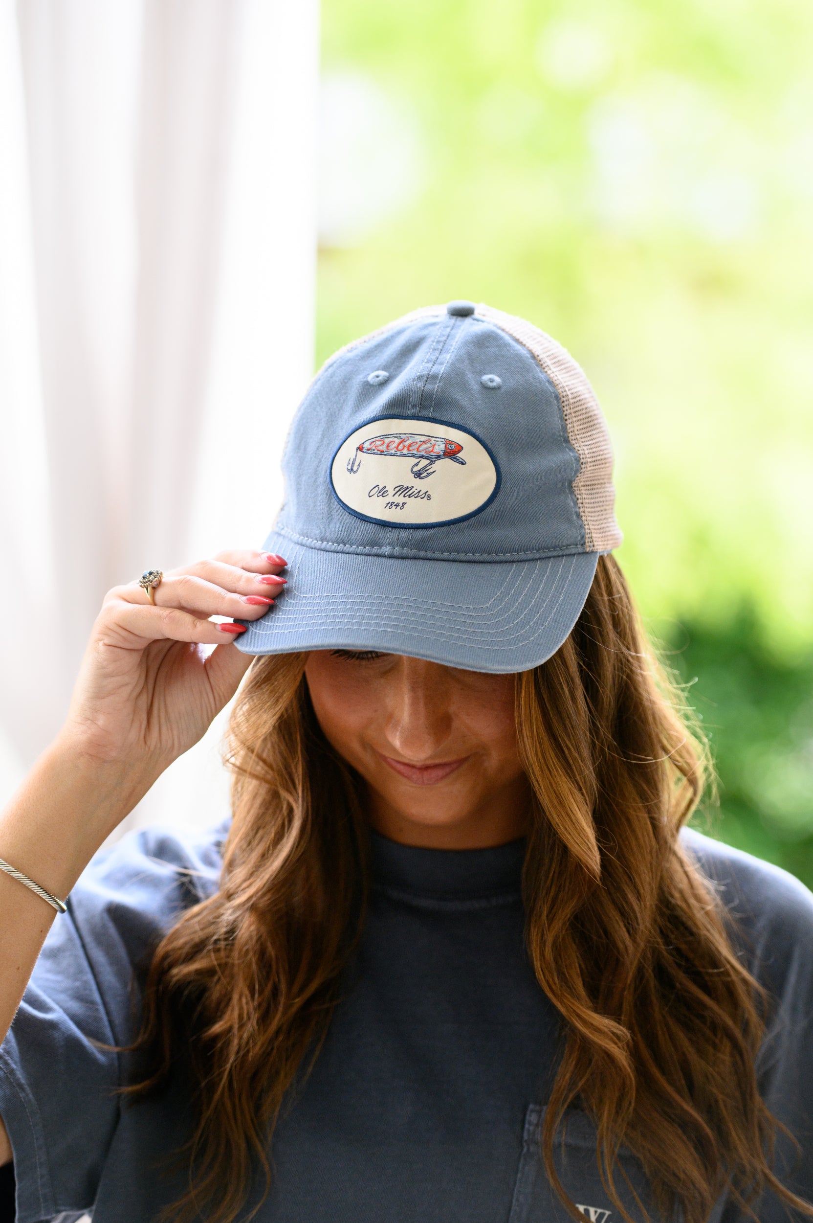 Ole Miss Dusty Blue Hat with a fishing lure with Red script “Rebels”