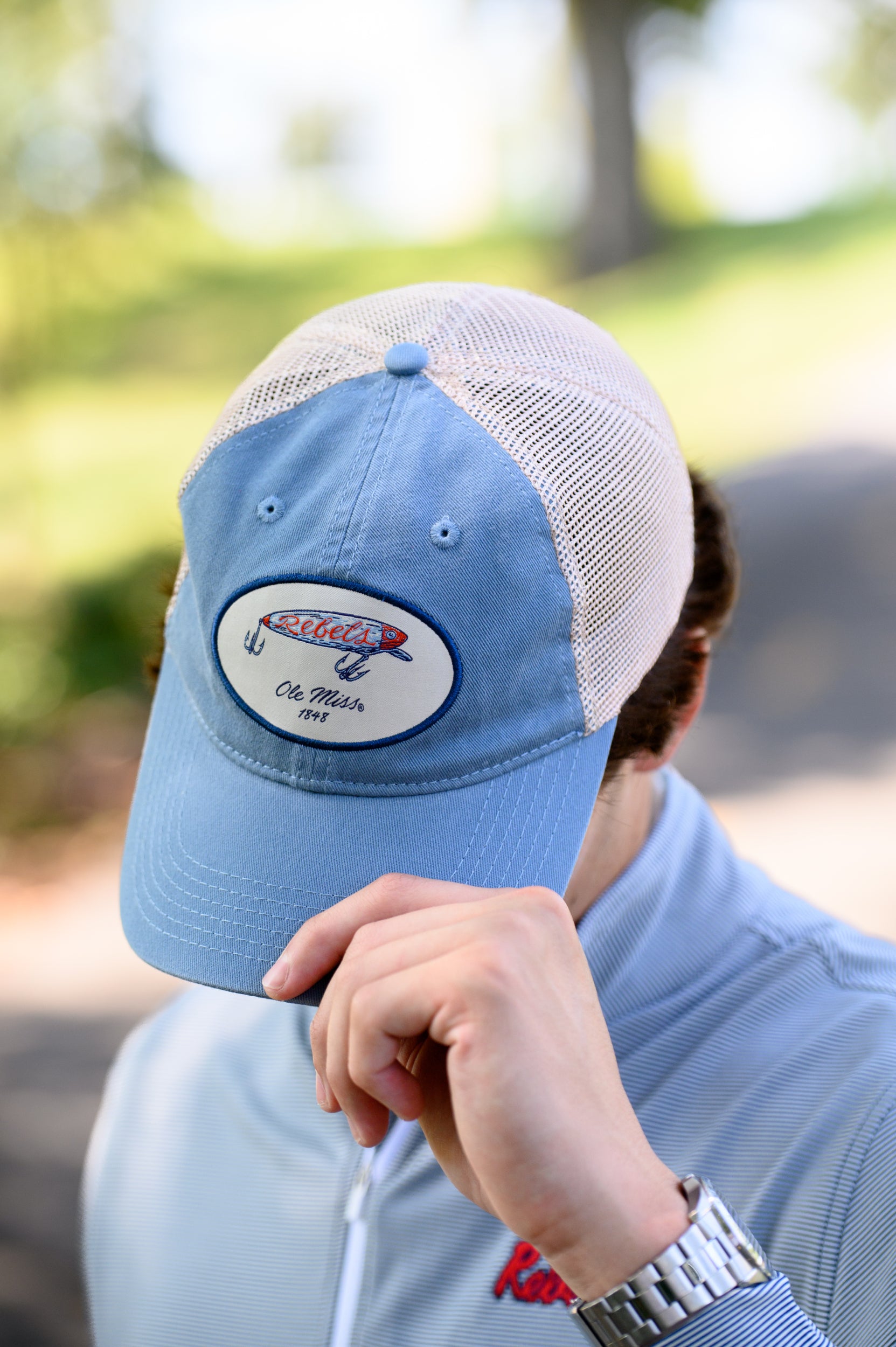 Ole Miss Dusty Blue Hat with a fishing lure with Red script “Rebels”