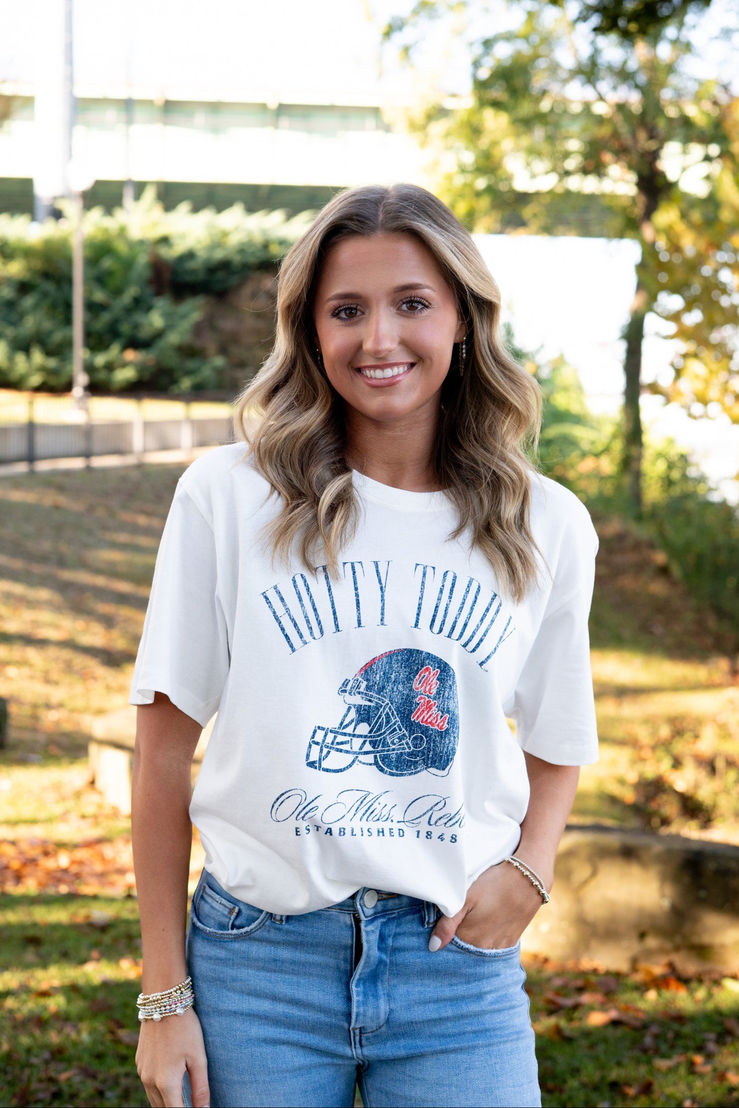 Ole Miss Ivory T-Shirt with Blue text “Hotty Toddy” above an image of a football helmet