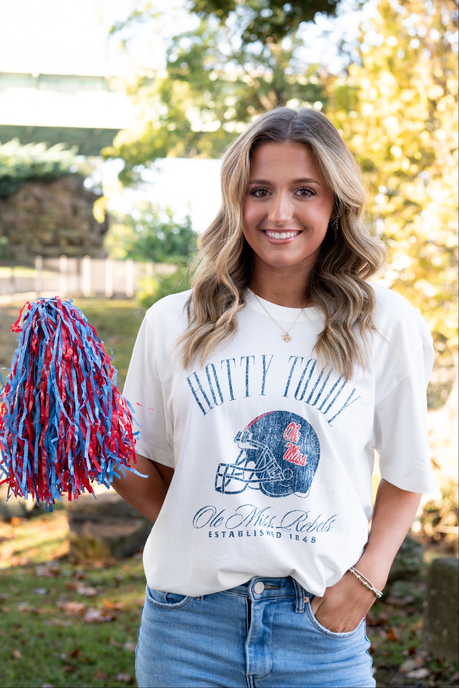 Ole Miss Ivory T-Shirt with Blue text “Hotty Toddy” above an image of a football helmet