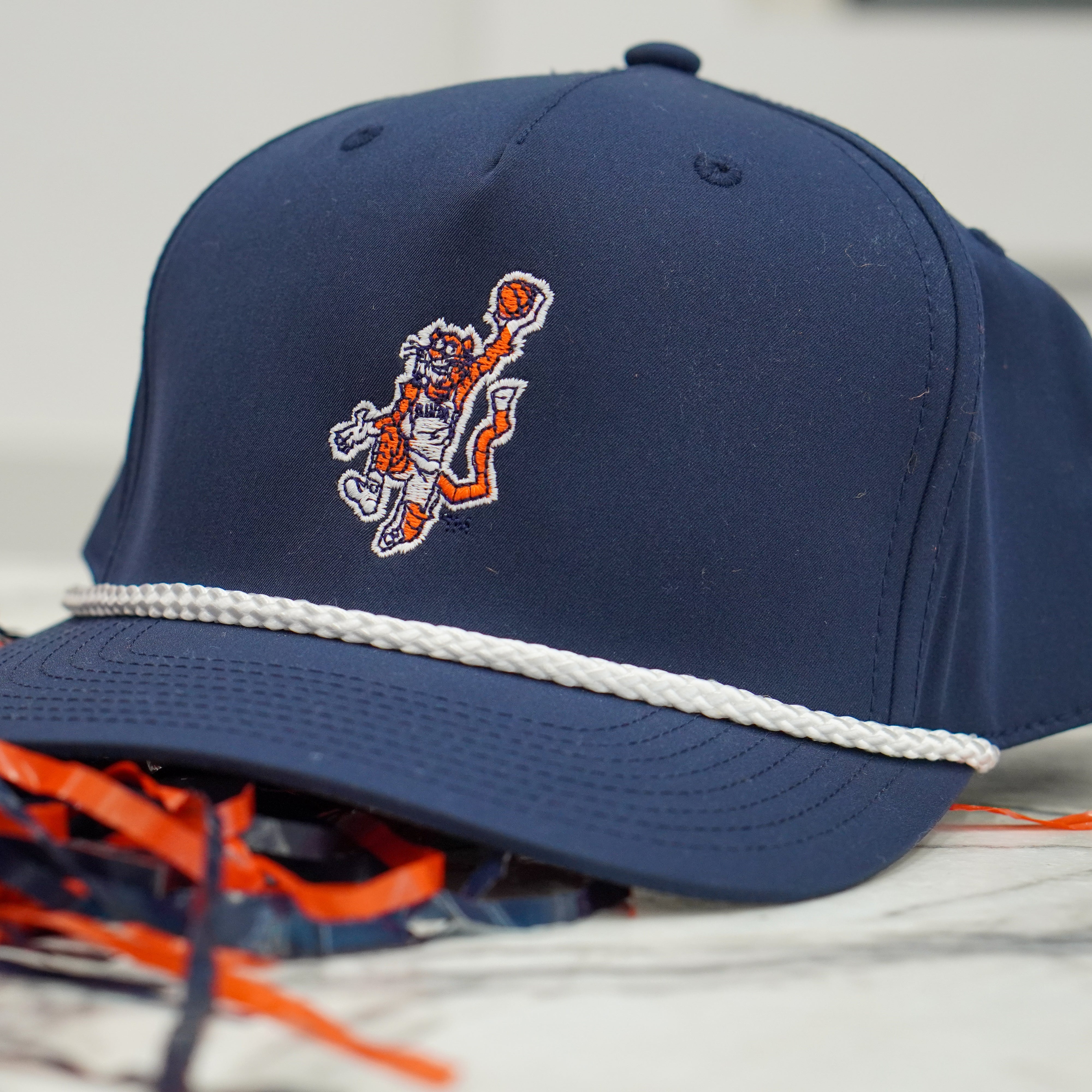 Auburn University Navy Hat with a White Rope and a patch or the Original Aubie dunking a Basketball