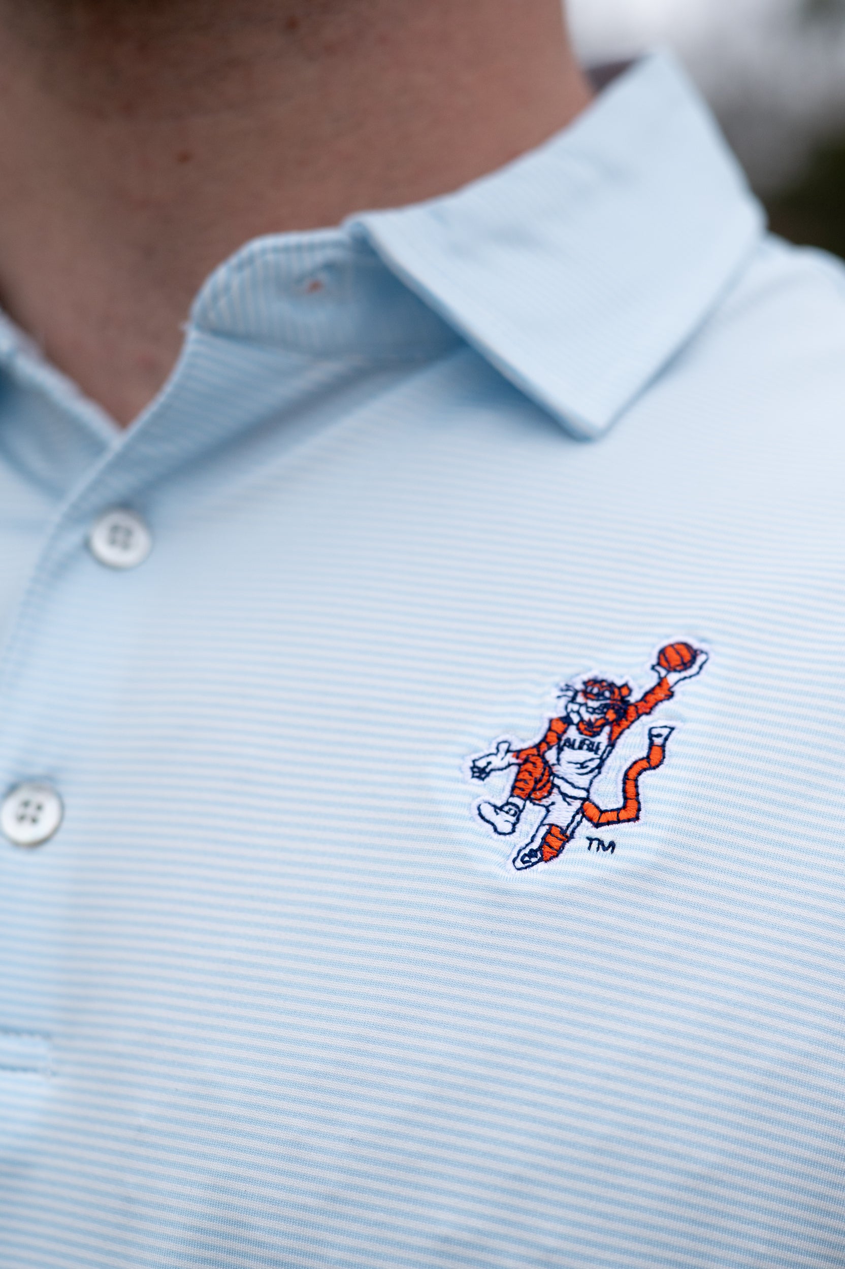 Auburn University Light Blue Men’s Stripe Polo with the Original Aubie Basketball Logo embroidery