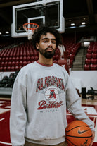 University of Alabama Heather Grey Sweatshirt with Plaid text “Alabama” above a Vintage A Logo Basketball and Red text “Basketball” underneath, with Black text “The Plaid Palace” across the bottom of the design