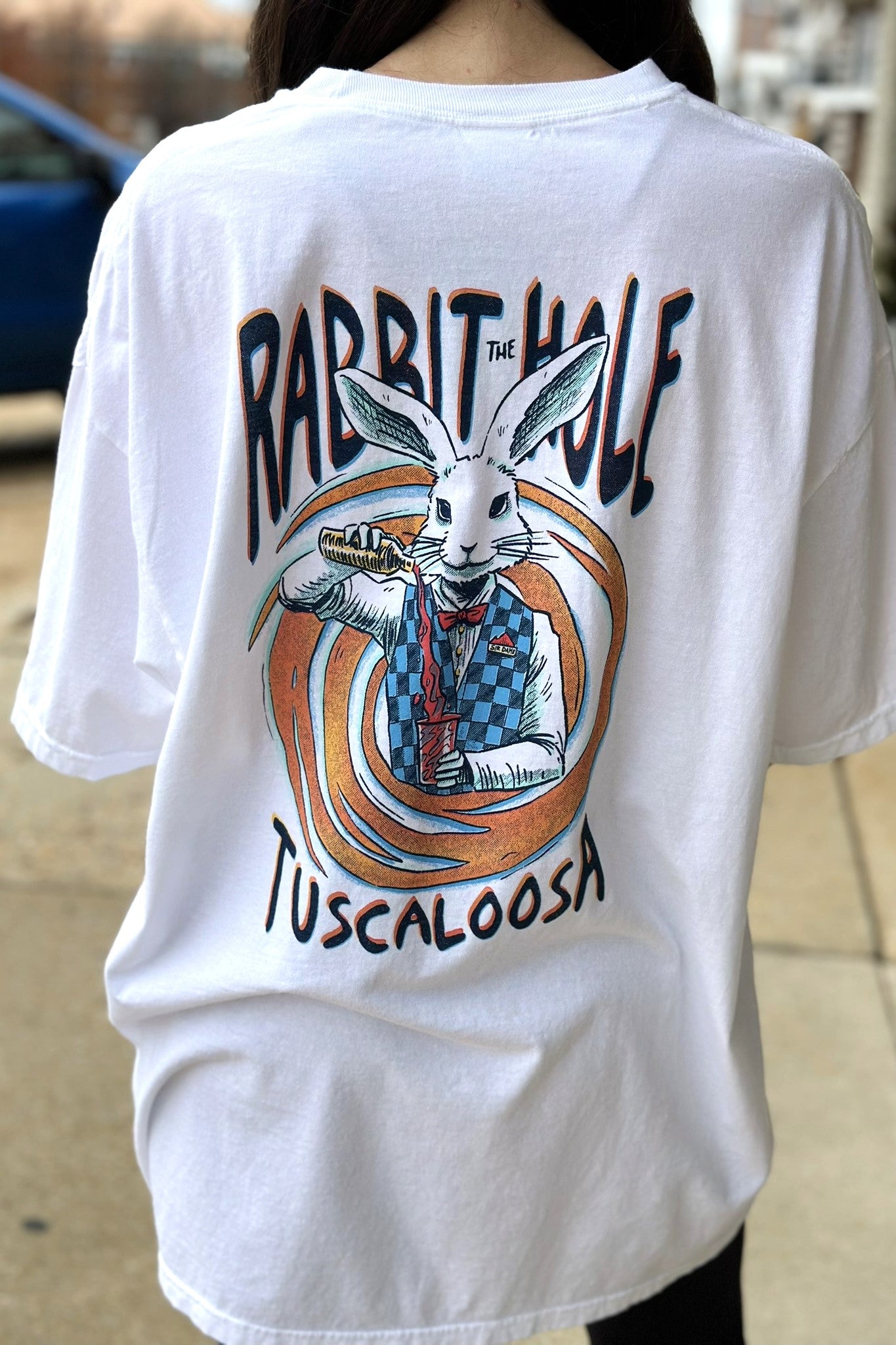 The Rabbit Hole White T-Shirt with an image of The White Rabbit serving a cocktail