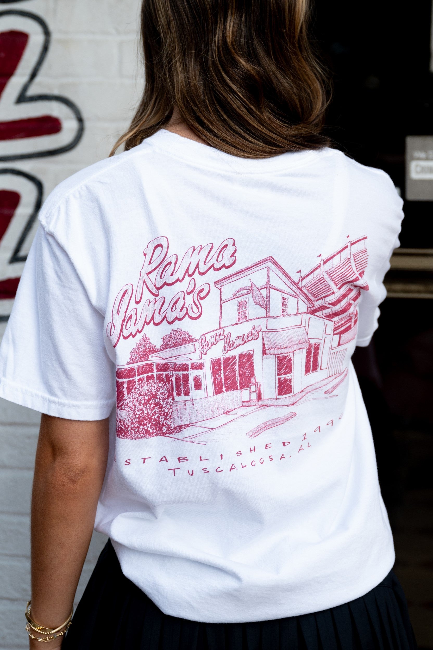 Rama Jama's White Tee with a Red illustration of the Rama Jama's Building 