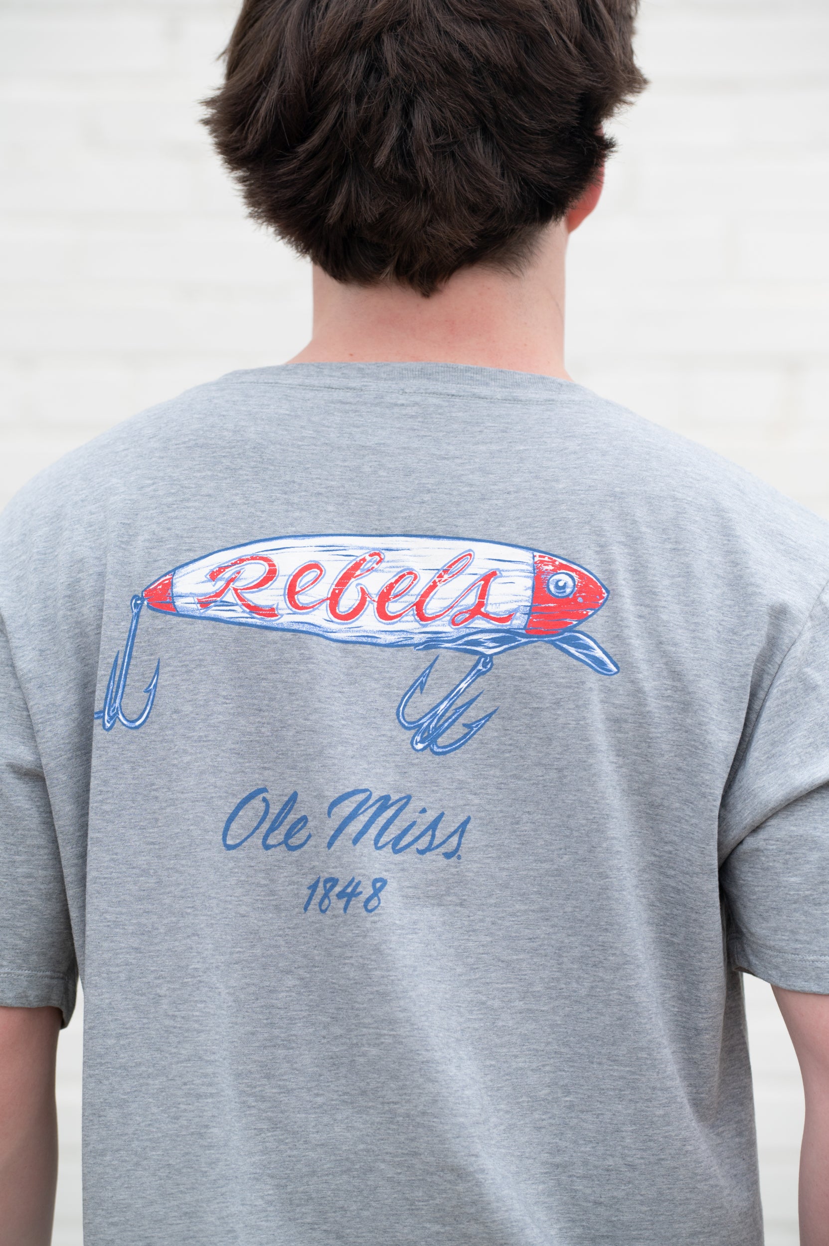 Ole Miss Grey T-Shirt with a fishing lure with Red script “Rebels”
