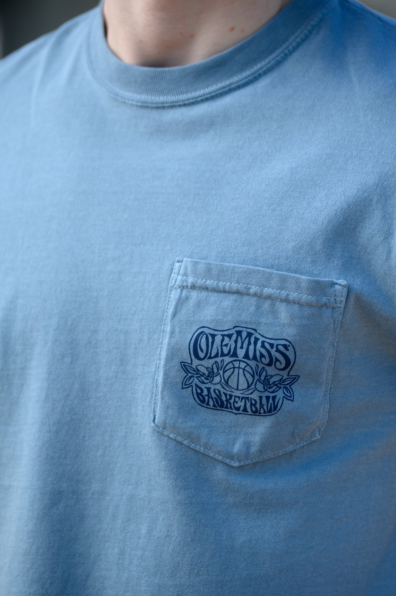 Ole Miss Blue T-Shirt with an "Ole Miss Basketball" front pocket design