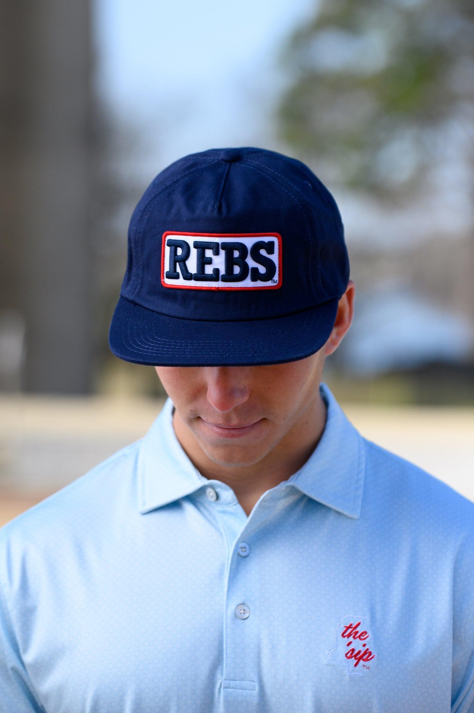 Ole Miss Navy Snapback Hat featuring a White patch with Navy “REBS” embroidery
