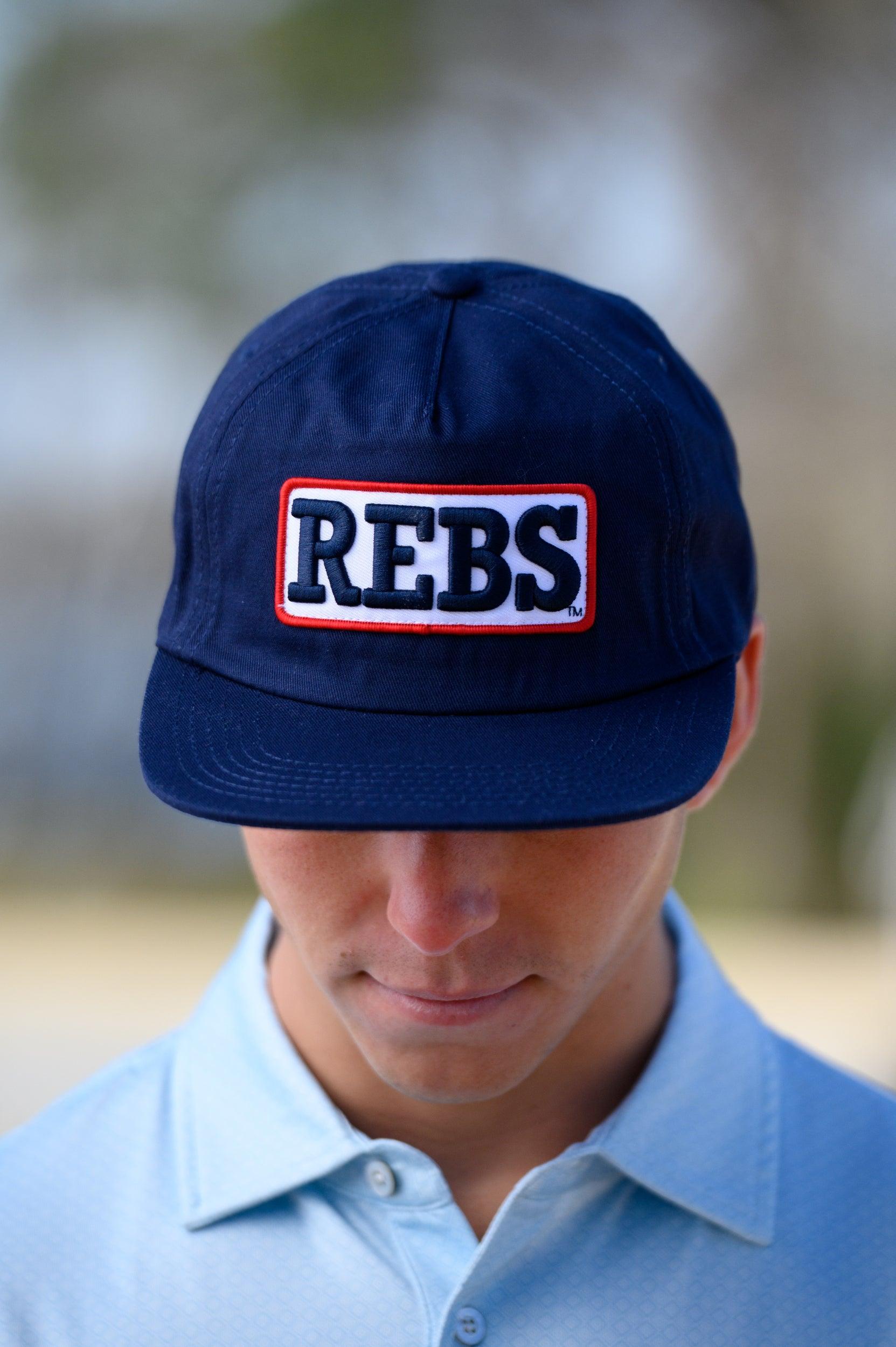 Ole Miss Navy Snapback Hat featuring a White patch with Navy “REBS” embroidery