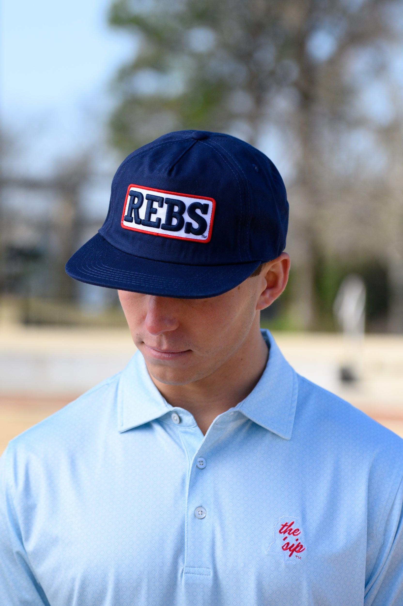 Ole Miss Navy Snapback Hat featuring a White patch with Navy “REBS” embroidery
