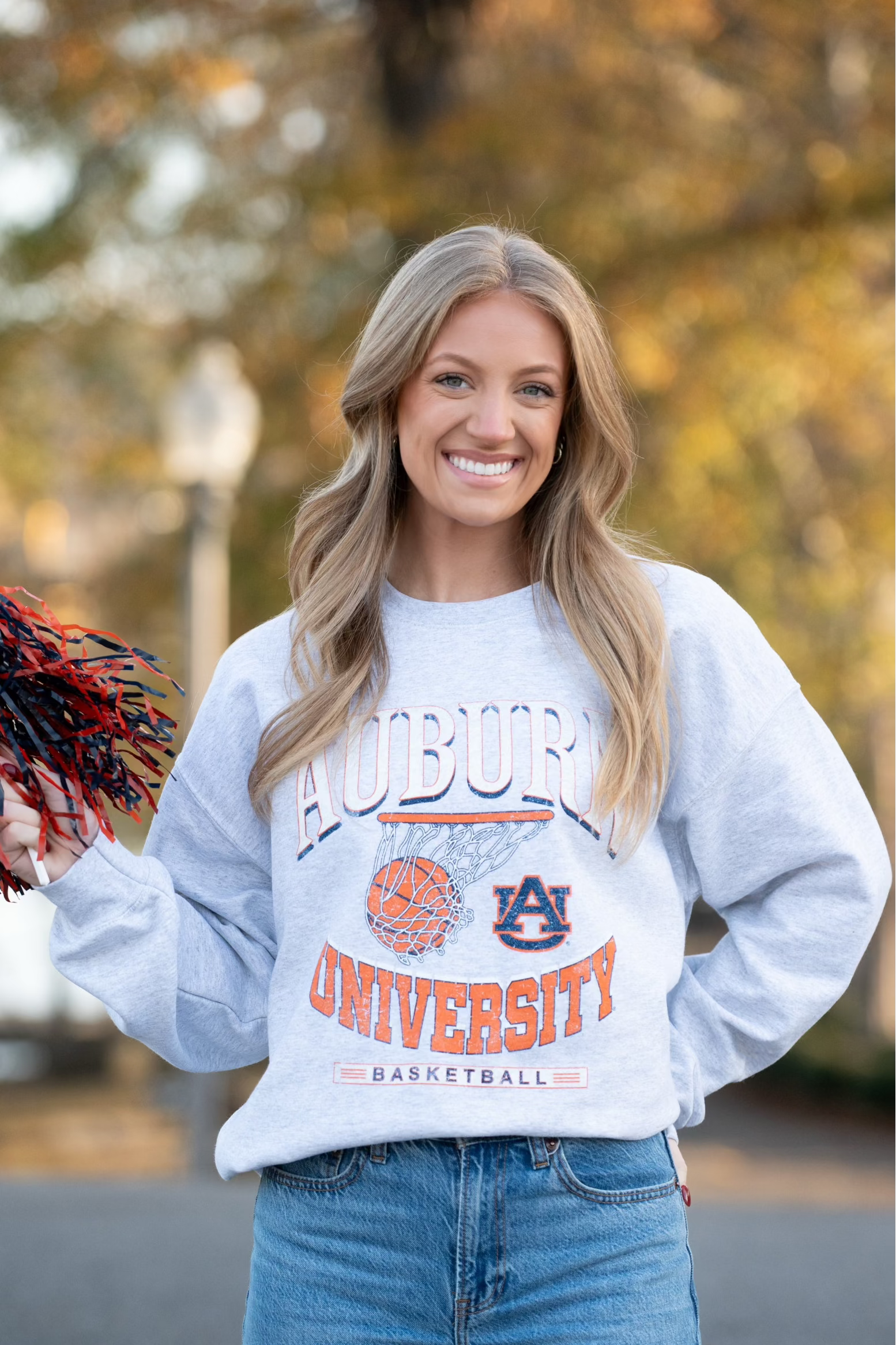 Auburn University Light Grey Heather Sweatshirt with a basketball landing in a hoop between text “Auburn” and “University Basketball” 
