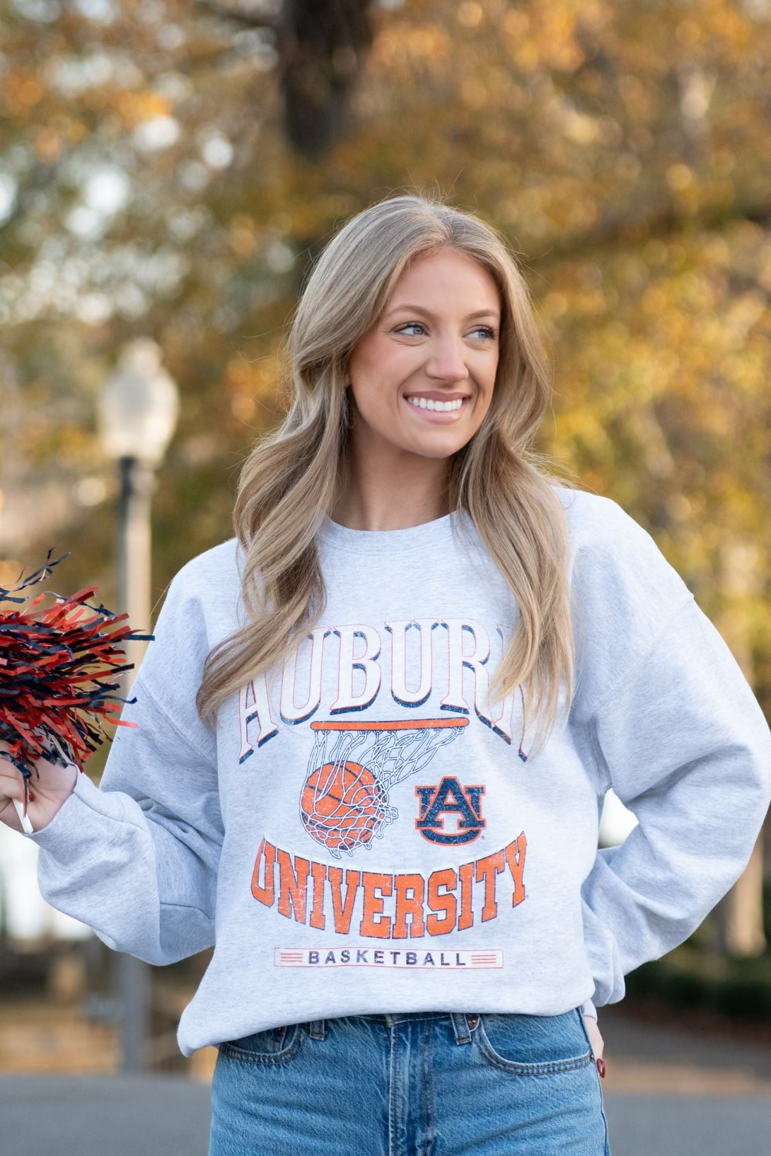 Auburn University Light Grey Heather Sweatshirt with a basketball landing in a hoop between text “Auburn” and “University Basketball” 