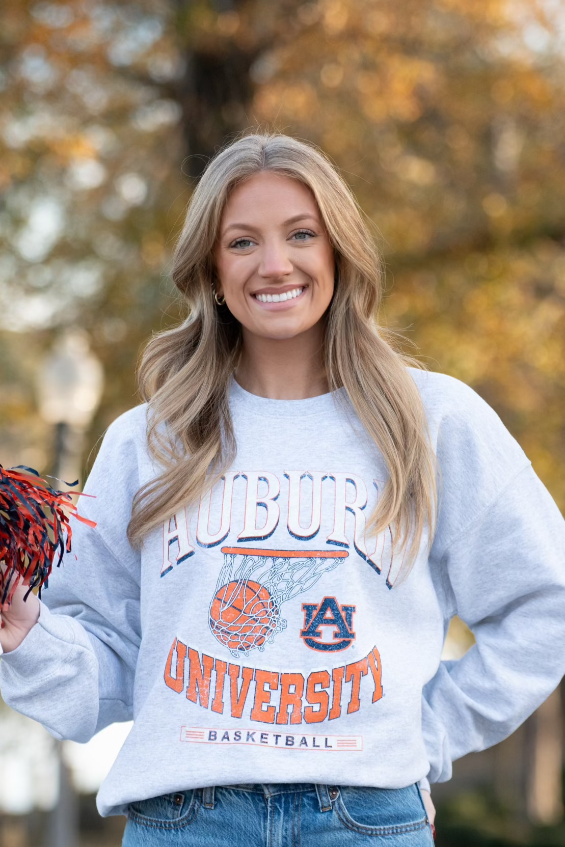Auburn University Light Grey Heather Sweatshirt with a basketball landing in a hoop between text “Auburn” and “University Basketball” 