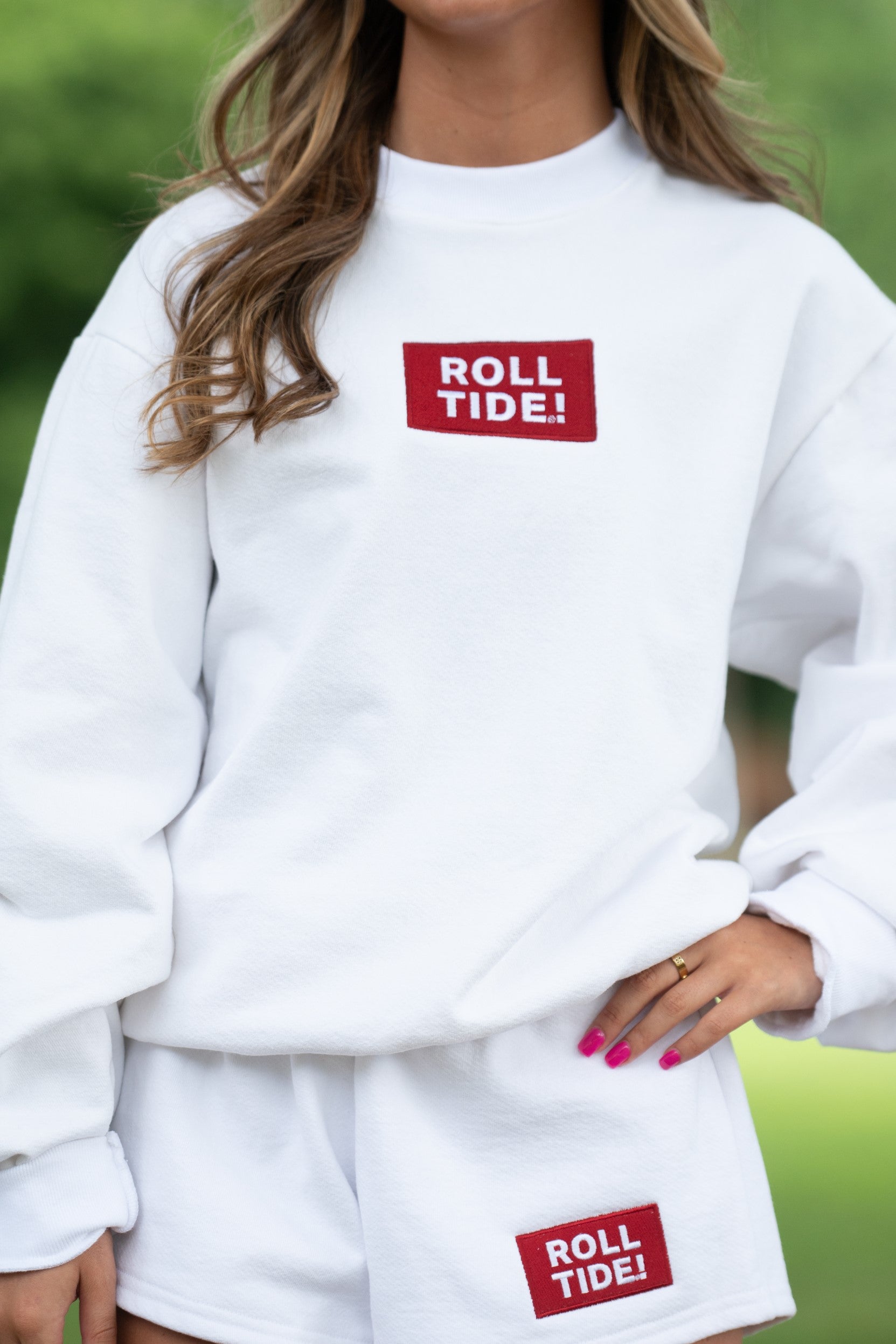 University of Alabama White Roll Tide Sweatshirt featuring a Red and White embroidered patch with text "Roll Tide!"