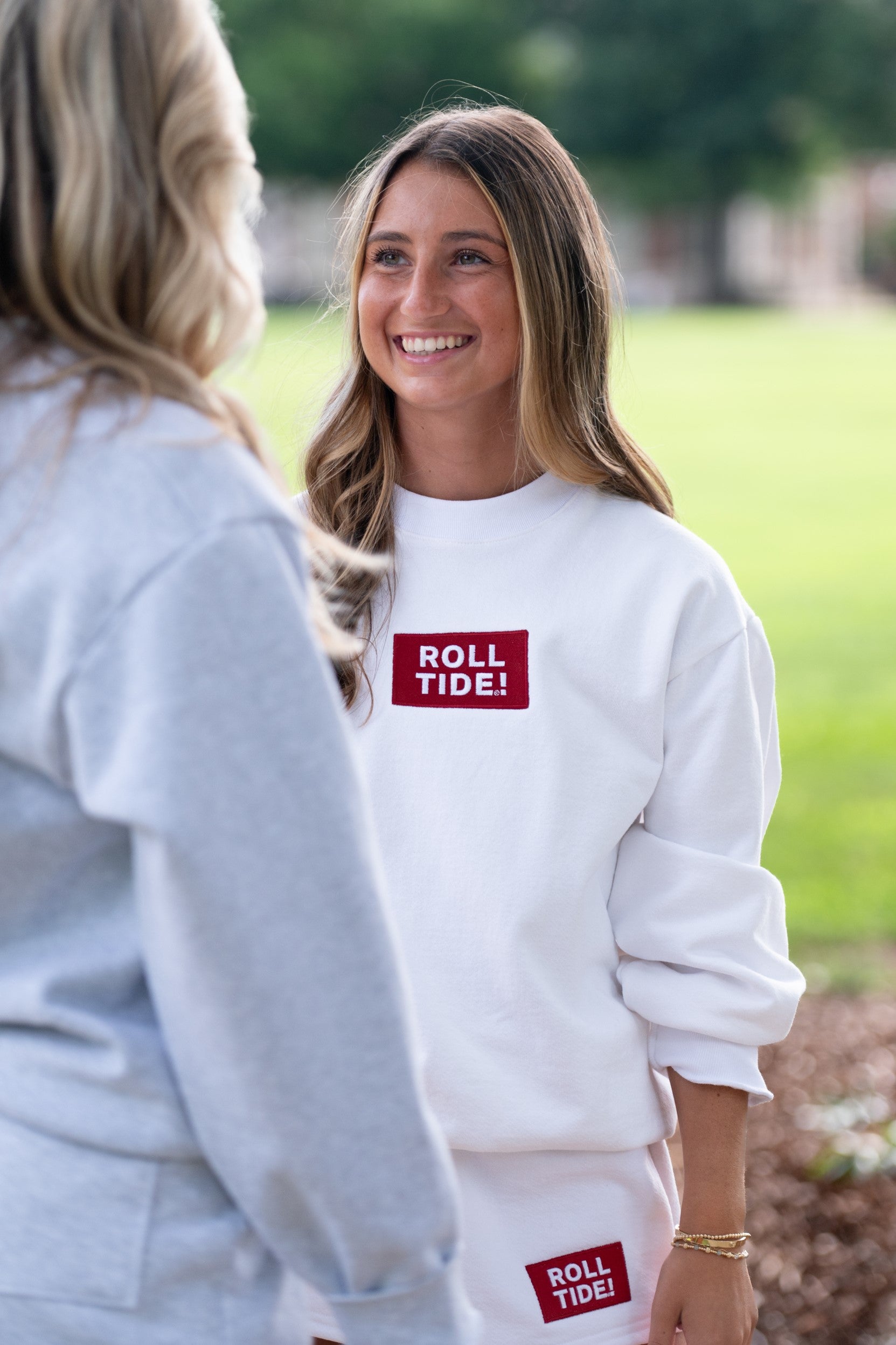 University of Alabama White Roll Tide Sweatshirt featuring a Red and White embroidered patch with text "Roll Tide!"