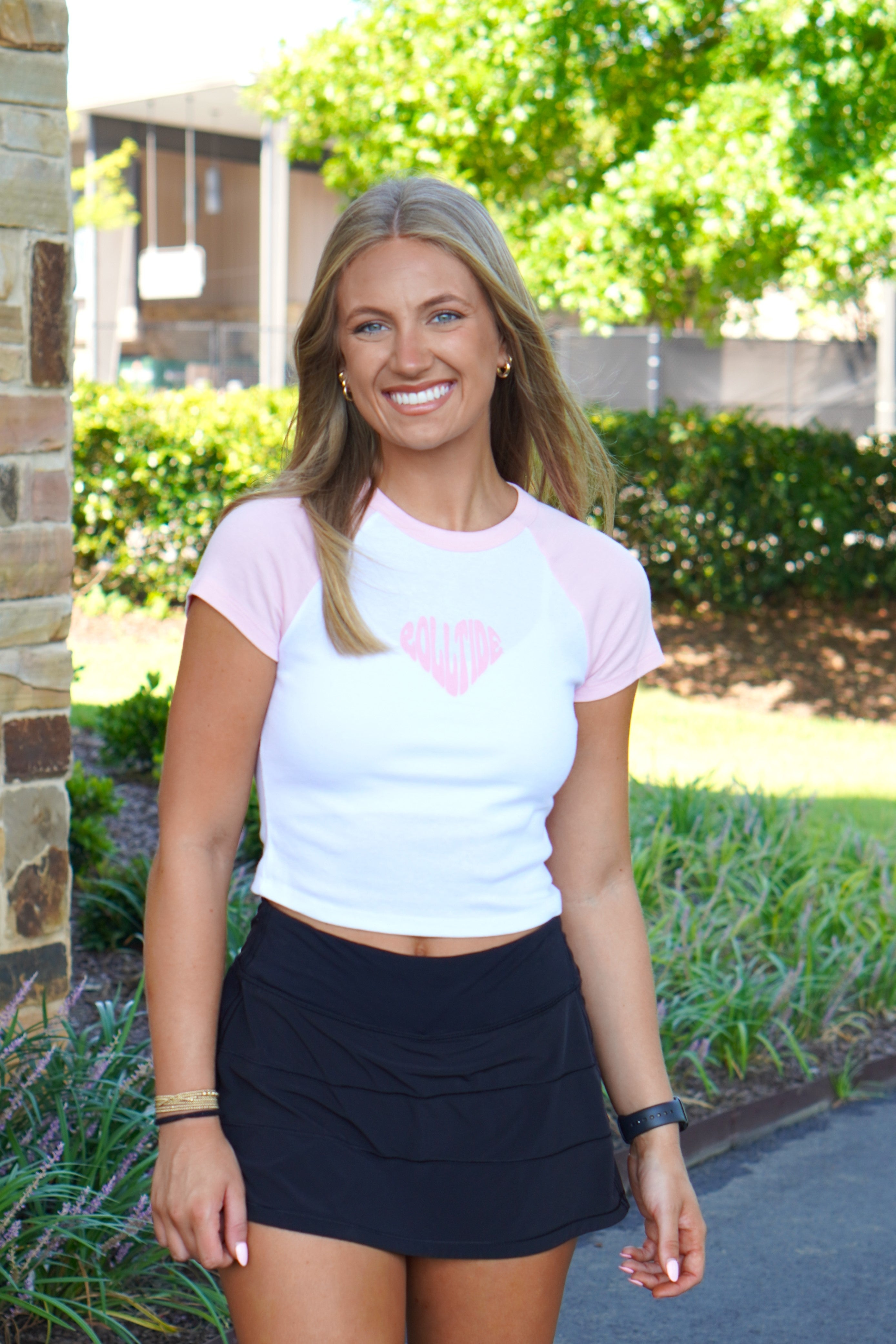 University of Alabama Pink and White Baby Tee with a Pink heart made of the text "Roll Tide"