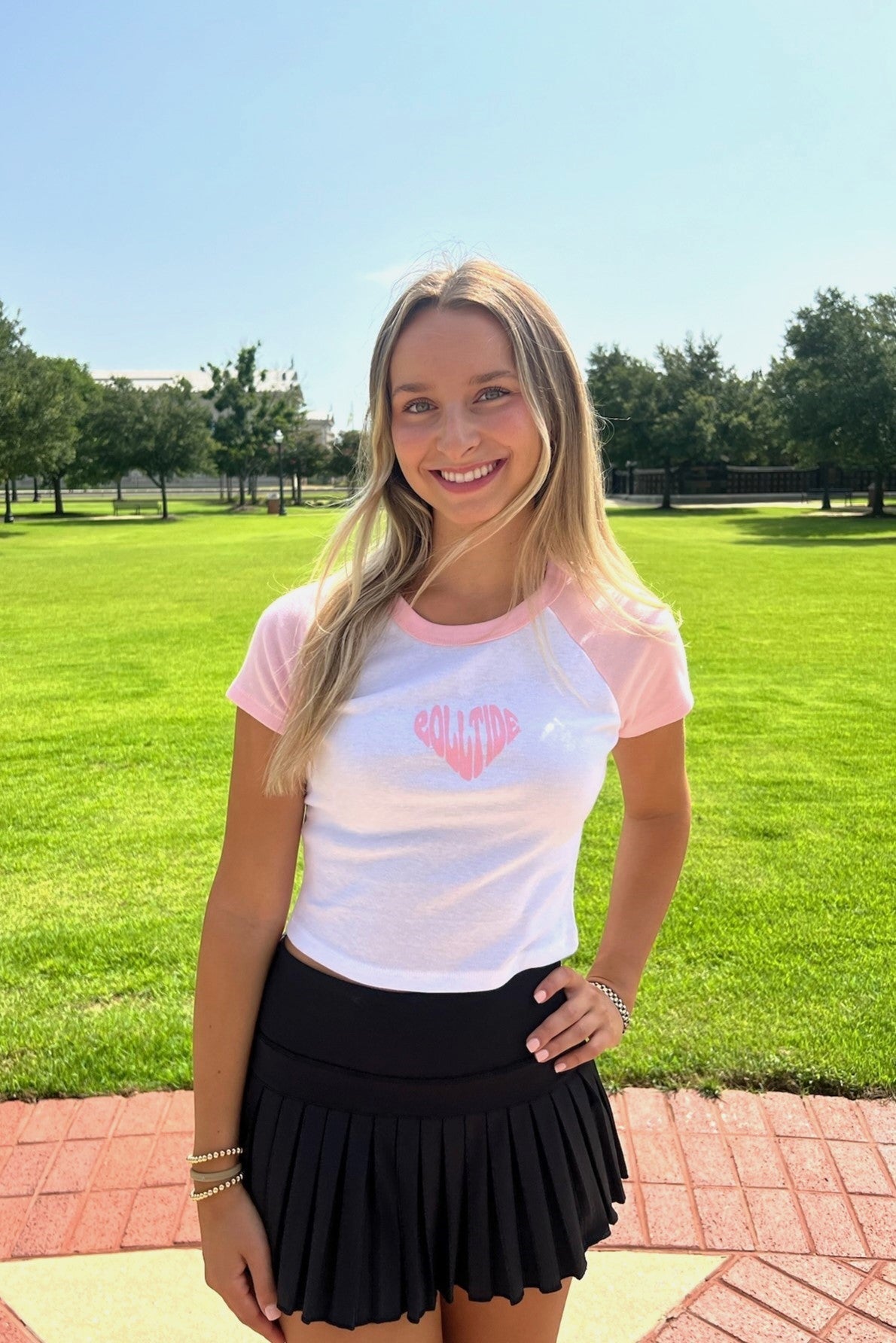 University of Alabama Pink and White Baby Tee with a Pink heart made of the text "Roll Tide"