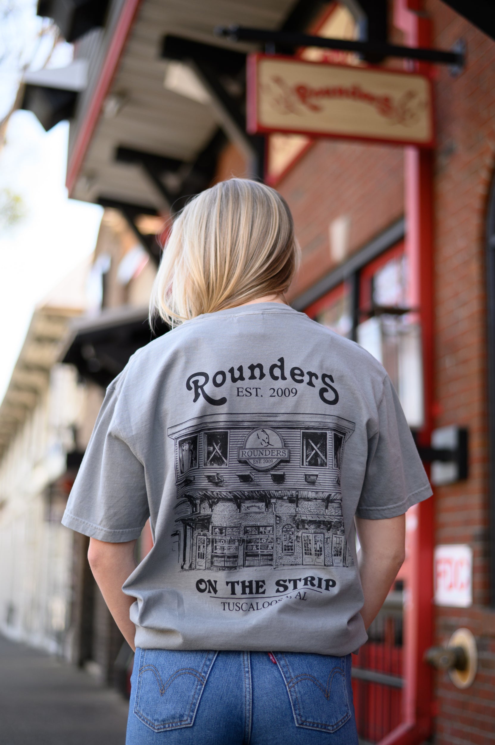 Rounders Grey Tee with a Black illustration of the Rounders Building