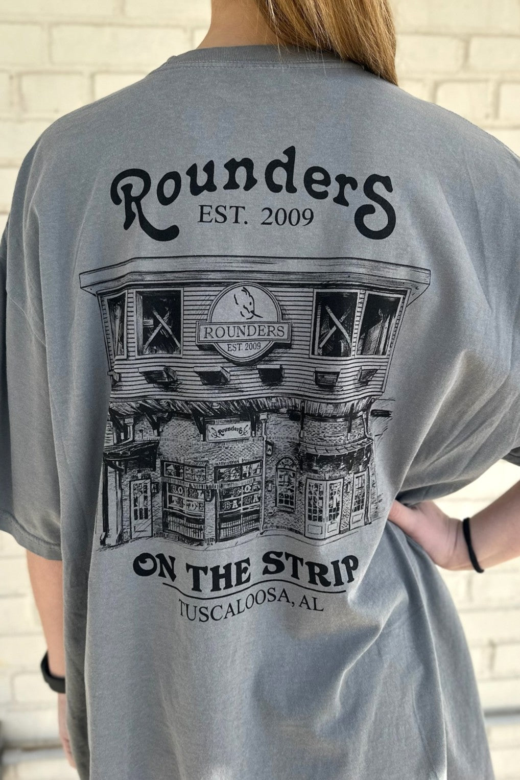 Rounders Grey Tee with a Black illustration of the Rounders Building