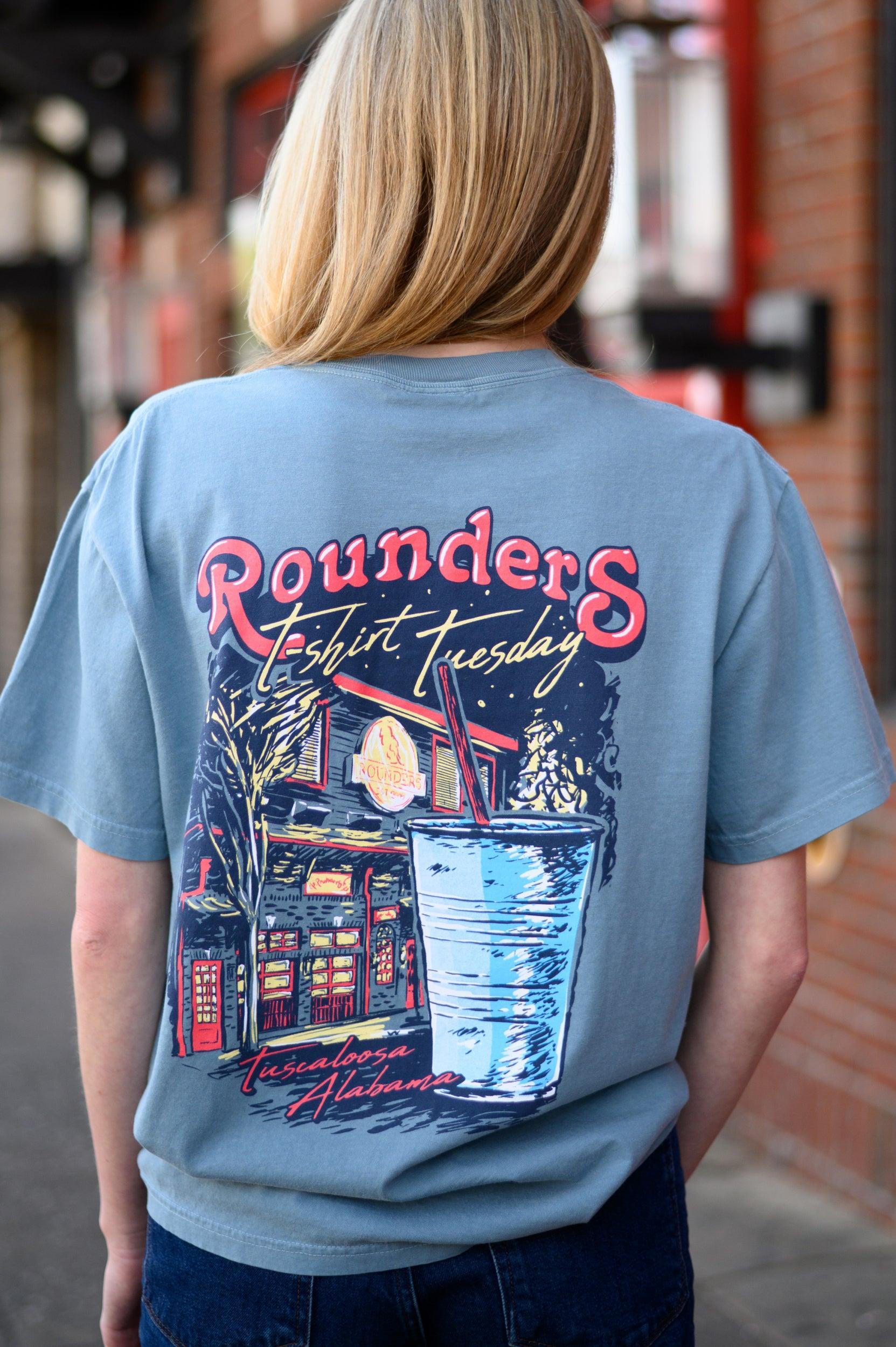 Rounders Blue T-Shirt with text "Rounders T-shirt Tuesday" above the Rounders Building and a Blue drink