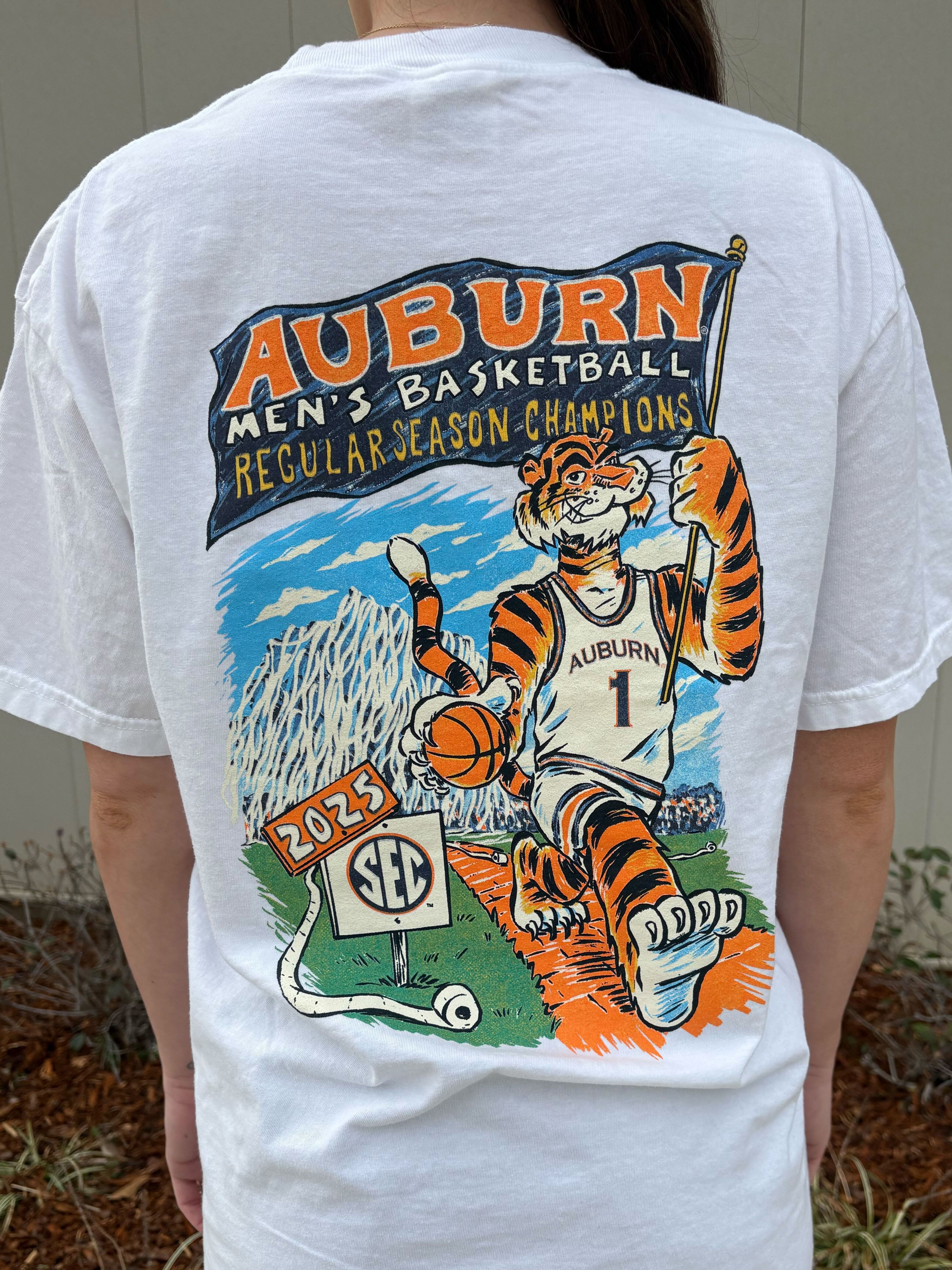 Auburn University White SEC Regulars T-Shirt with Aubie in basketball gear carrying a flag with text "Auburn Men's Basketball Regular Season Champions"