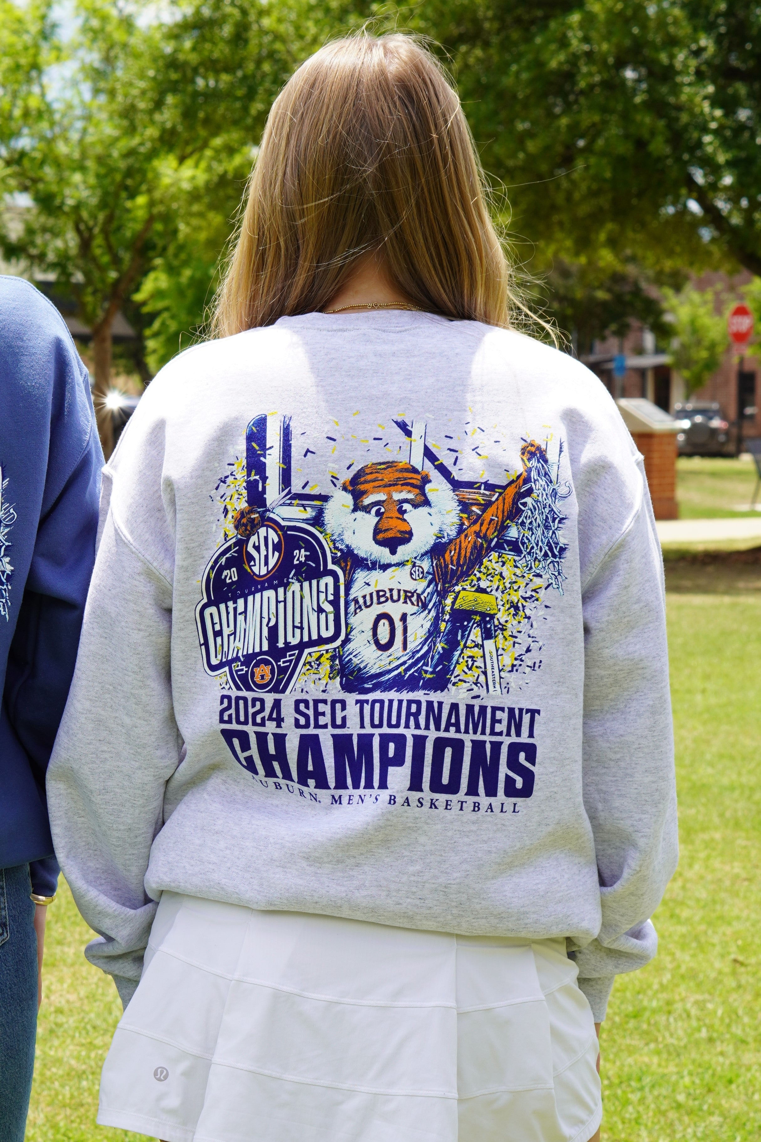 Auburn University Grey SEC Champions  Sweatshirt with an illustration of Aubie holding an "SEC Champions" sign while confetti pours down around him