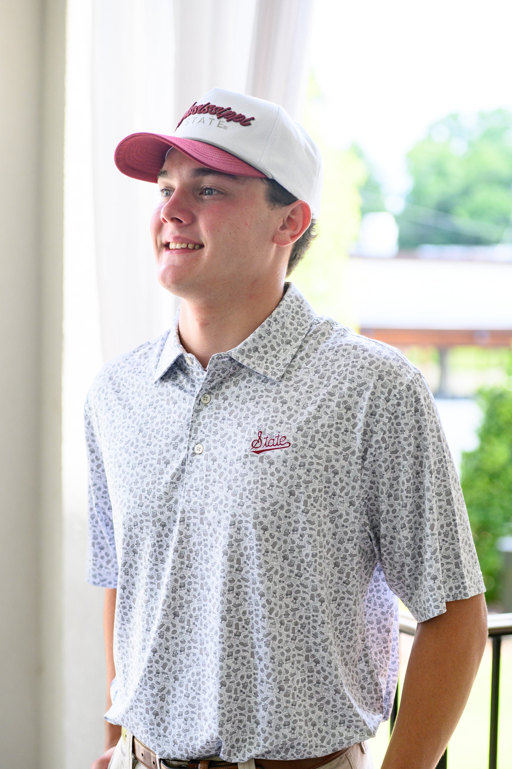 Mississippi State Grey Men’s Patterned Polo with a tailgate themed pattern and the Script State Logo embroidery