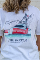 White t-shirt with a graphic of a boat and New Amsterdam branding, worn by a person.