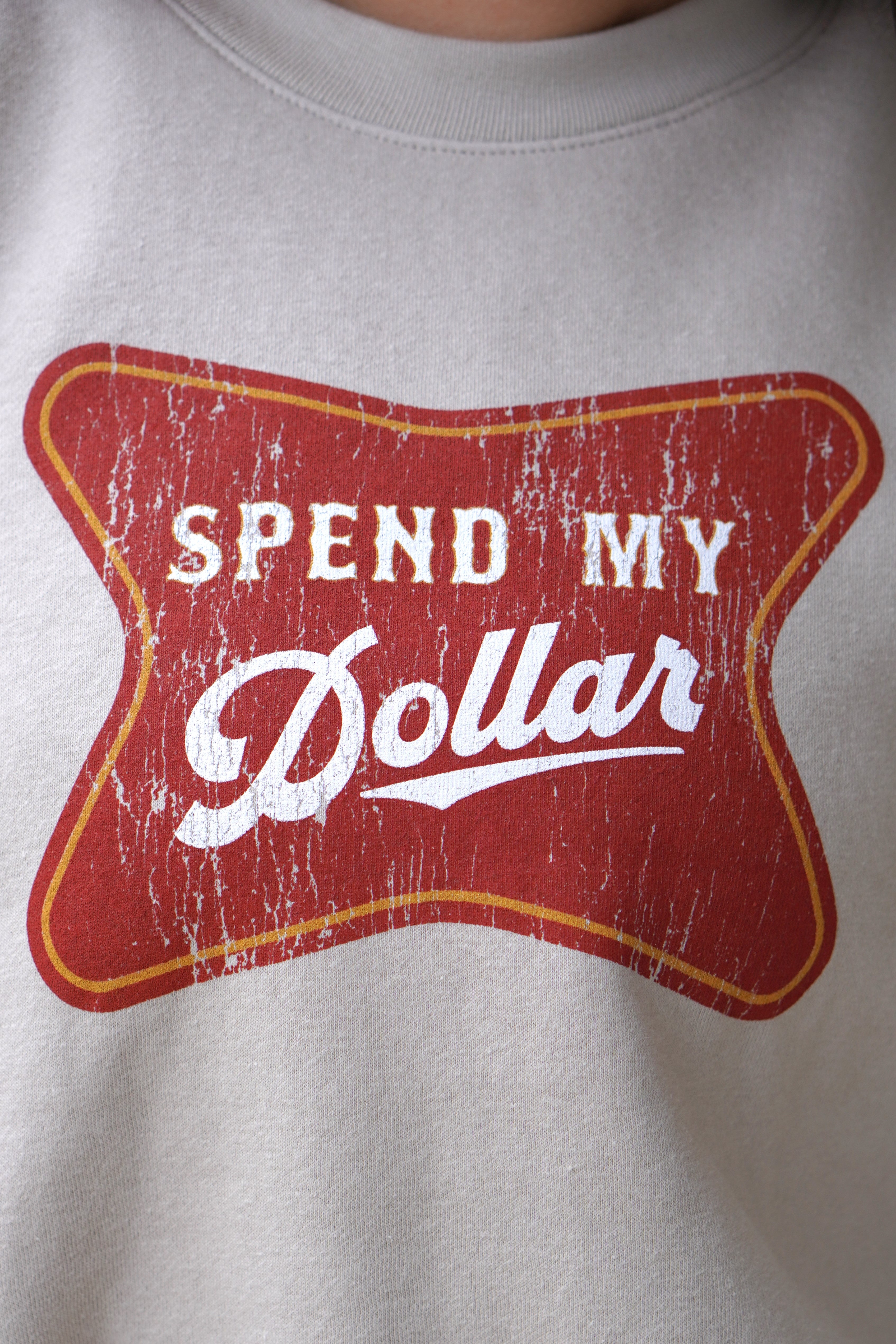 University of Alabama Bone Ladies' Crewneck featuring a Red sign with White text "Spend My Dollar"