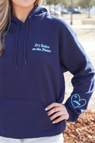 Auburn University Navy Ladies Hoodie with Light Blue text "It's Better on the Plains." (FRONT) | Light Blue heart with text "Auburn" inside (SLEEVE)