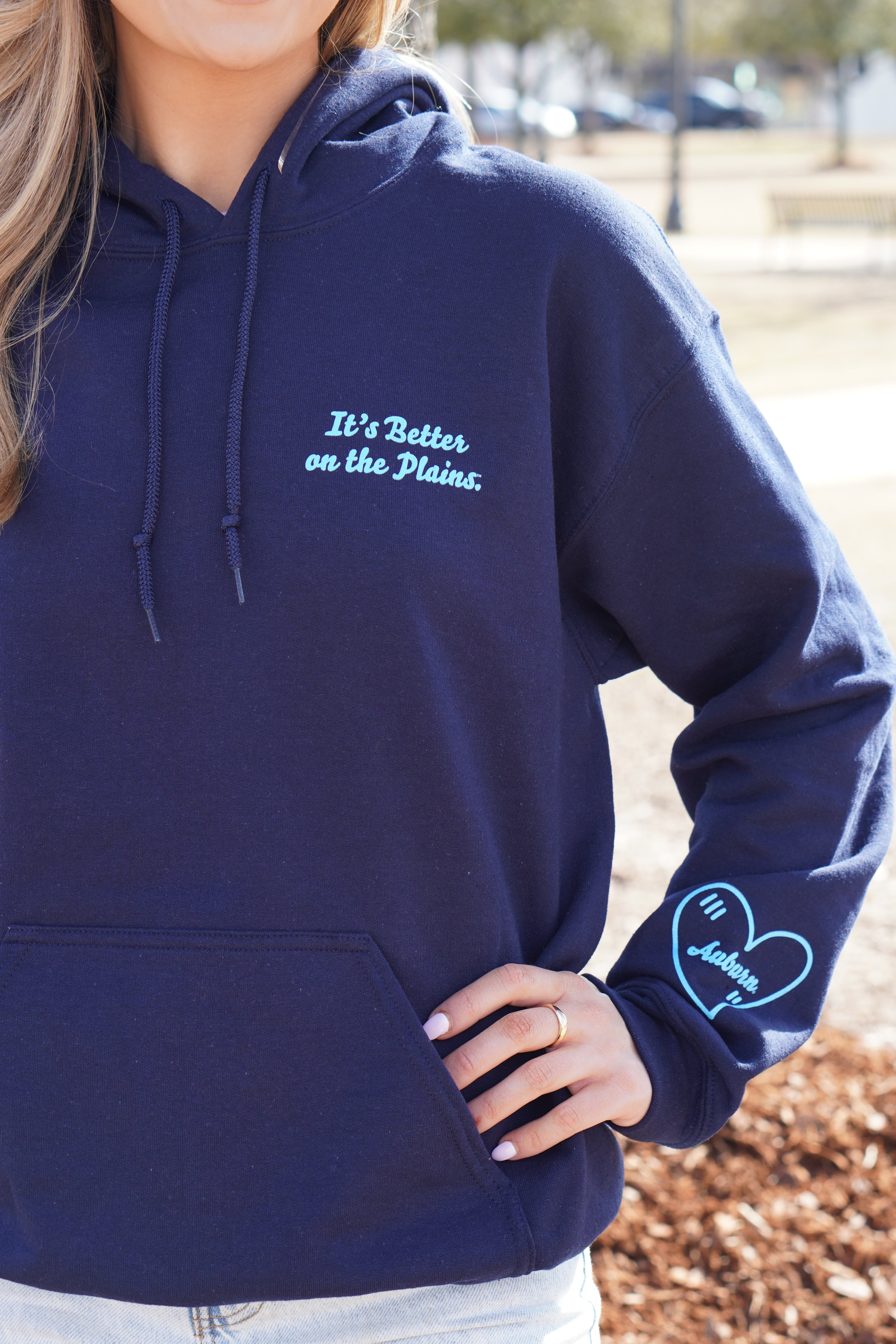 Auburn University Navy Ladies Hoodie with Light Blue text "It's Better on the Plains." (FRONT) | Light Blue heart with text "Auburn" inside (SLEEVE)
