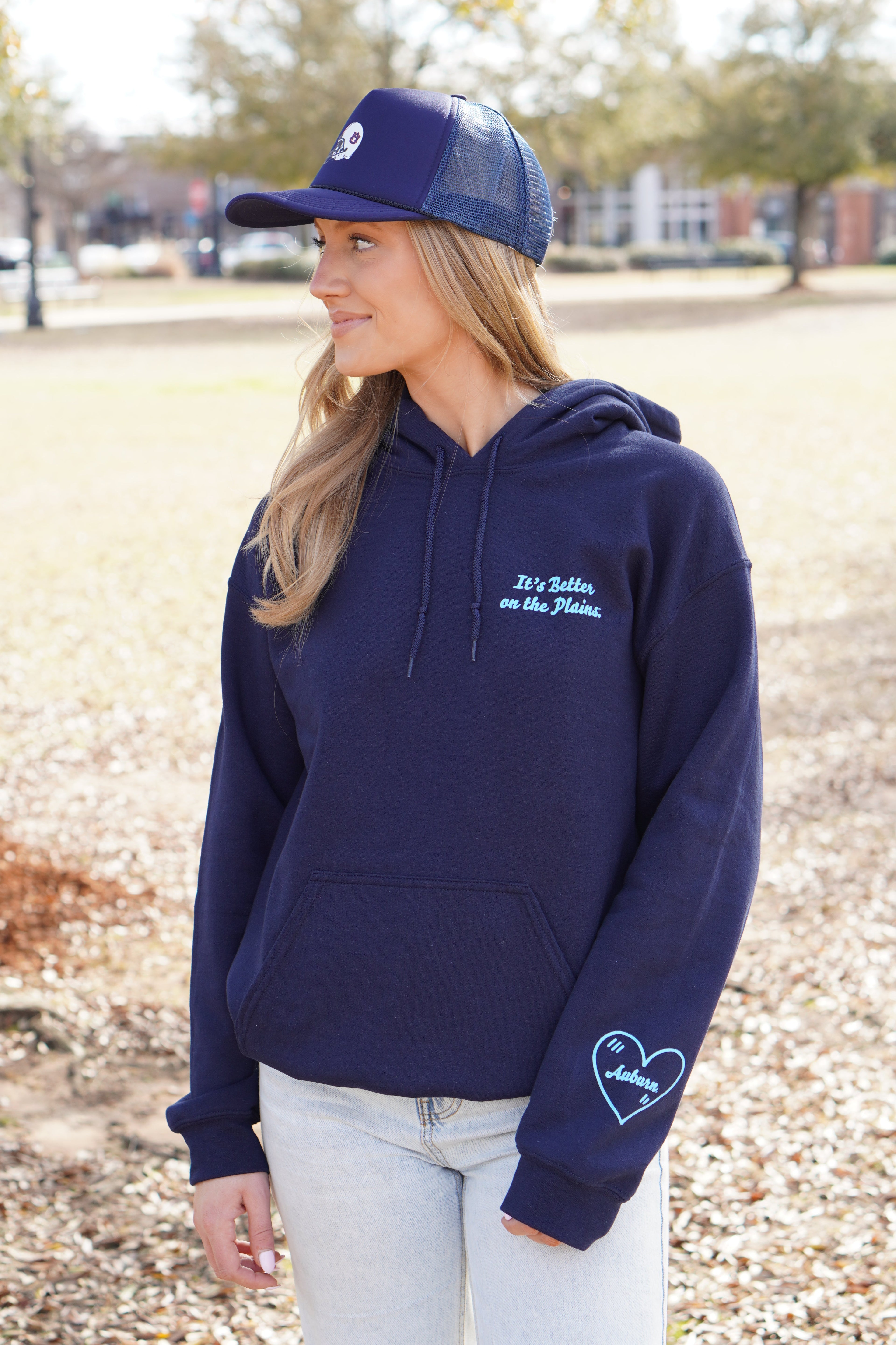 Auburn University Navy Ladies Hoodie with Light Blue text "It's Better on the Plains." (FRONT) | Light Blue heart with text "Auburn" inside (SLEEVE)
