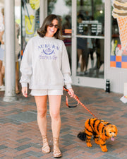 Auburn University Grey Mock Neck Sweatshirt with Navy Embroidered text “Auburn” above the tiger crest (A tiger head outline encircled by a wreath of laurels), and text “Fearless & True- The Plains”